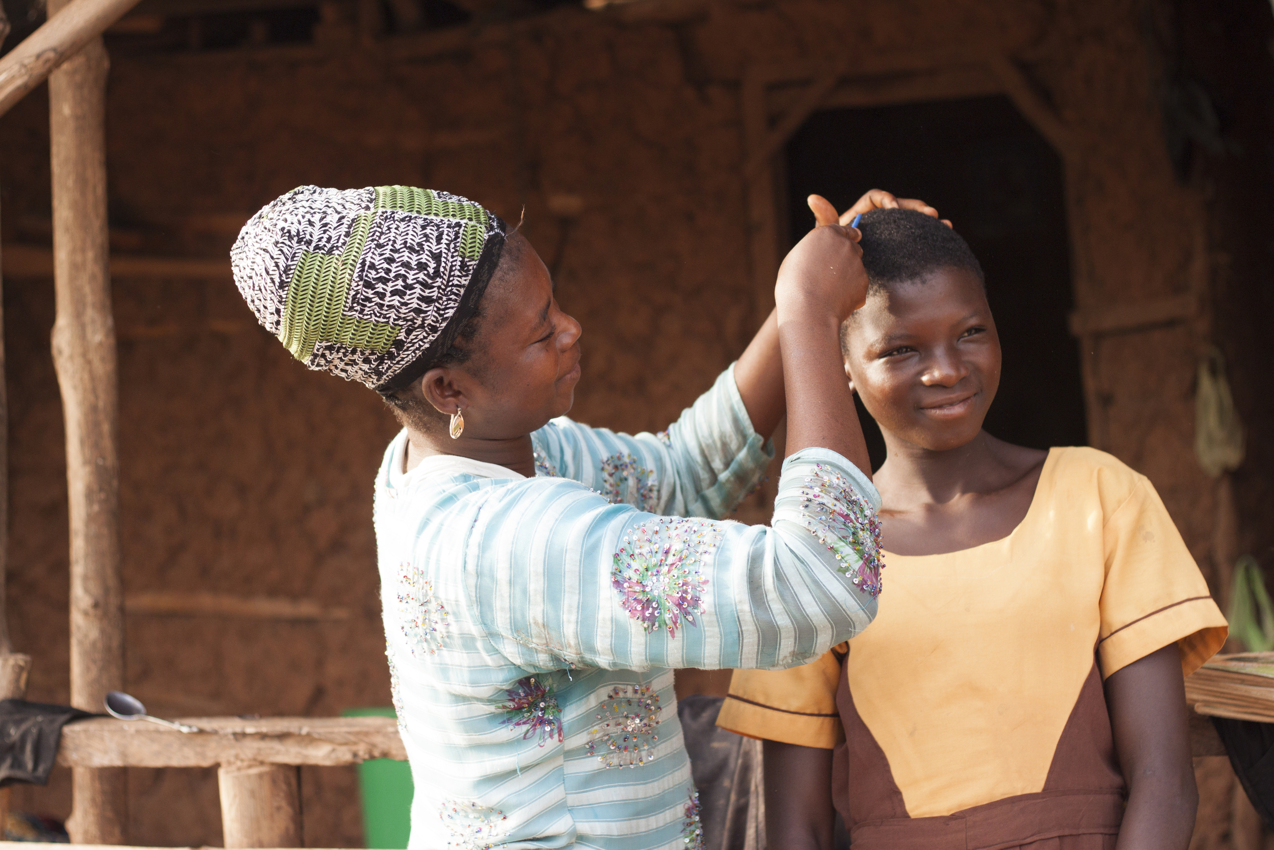 Mirabell's mother helping her get ready for school. 