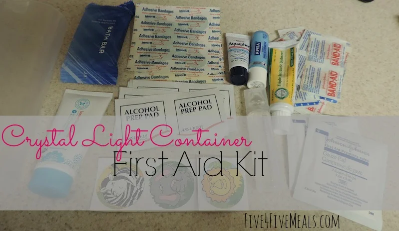 diaper bag first aid kit in an old crystal light container cover.jpg