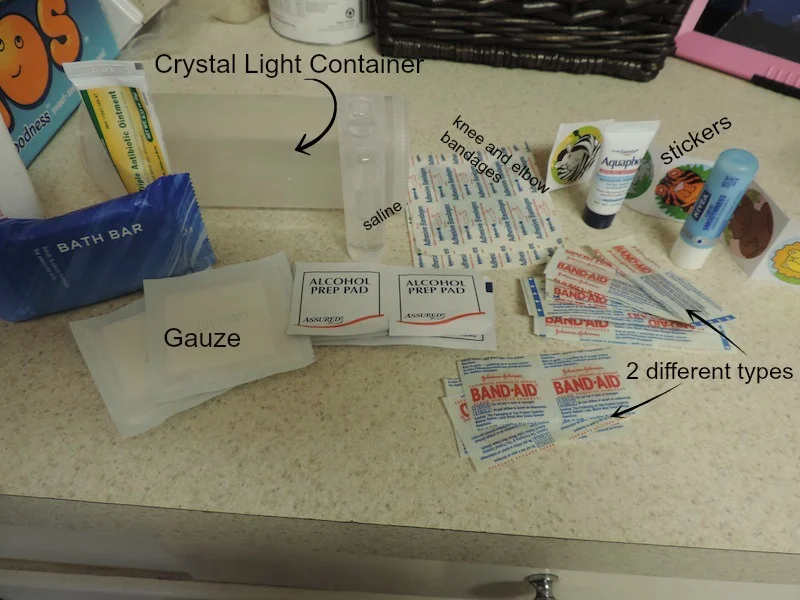 diaper bag first aid kit in an old crystal light container labeled contents.jpg