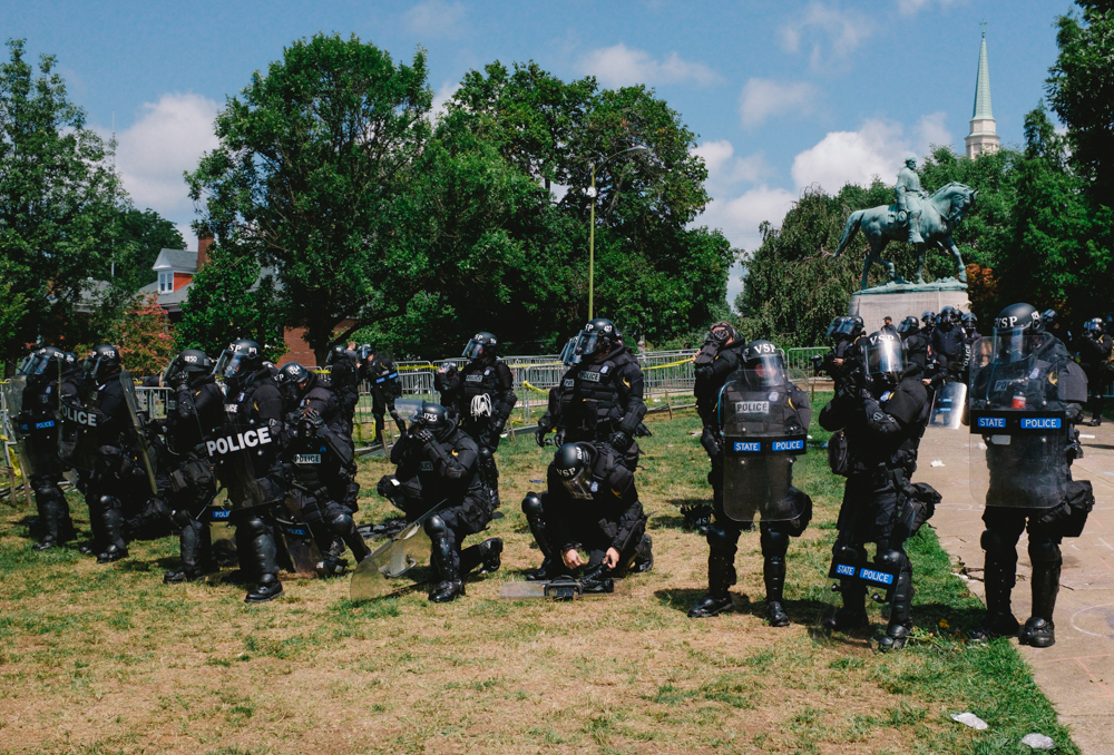 Police dressed in riot gear stand in front of a statue of Robert E. Lee in Emancipation Park shortly after clashes between white nationalists and counter-protesters broke out. (Seth Herald / The Atlantic)