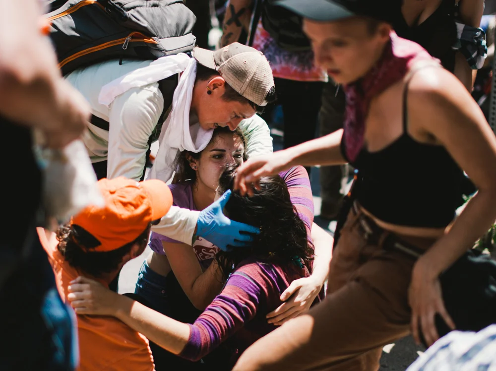 A woman is given medical treatment after she was struck by a car that drove into a crowd of counter-protesters in Charlottesville. (Seth Herald / The Atlantic)