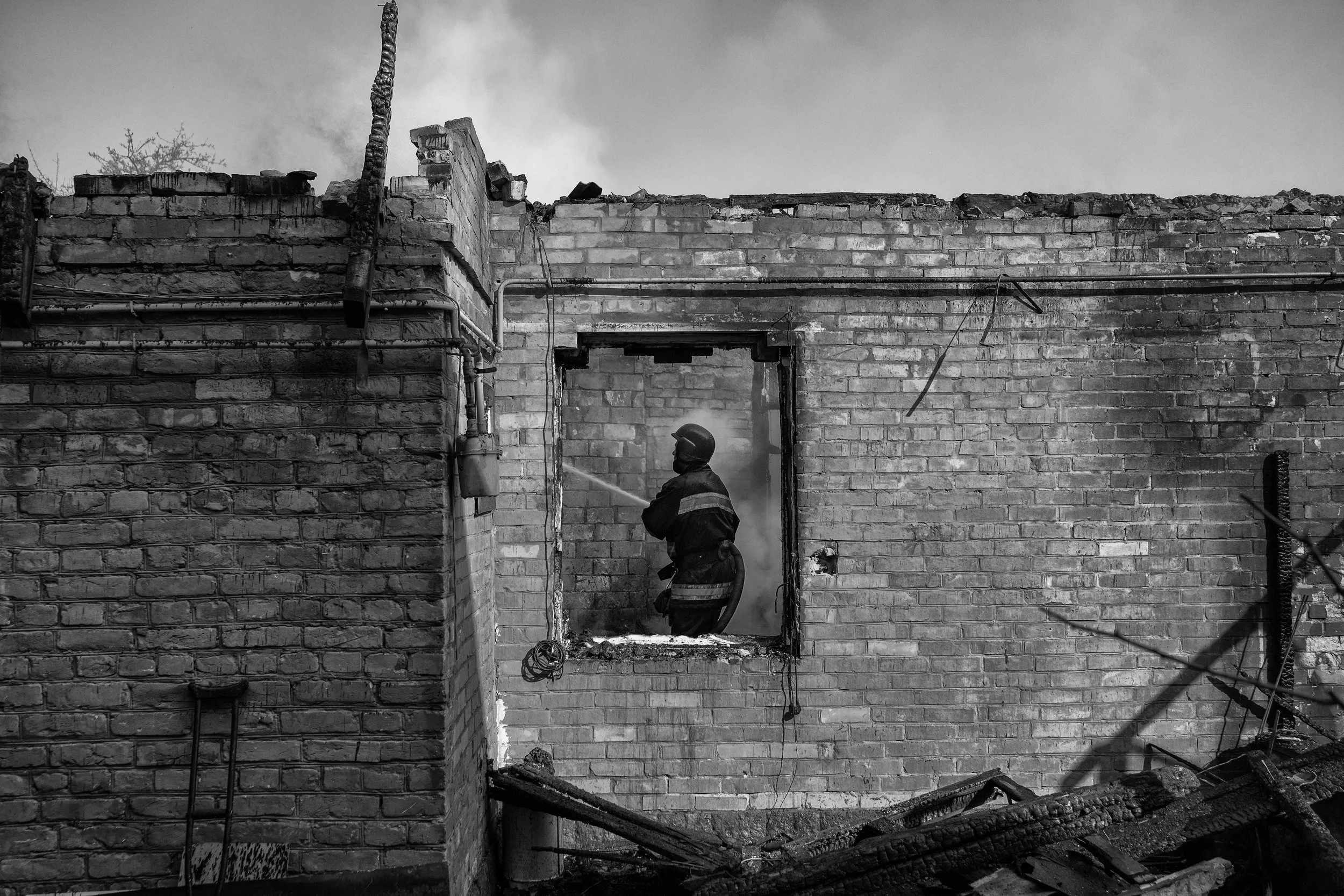  A firefighter puts out a fire of a home that was hit by a Russian rocket in Kyiv, Ukraine, on March 23,2022. 