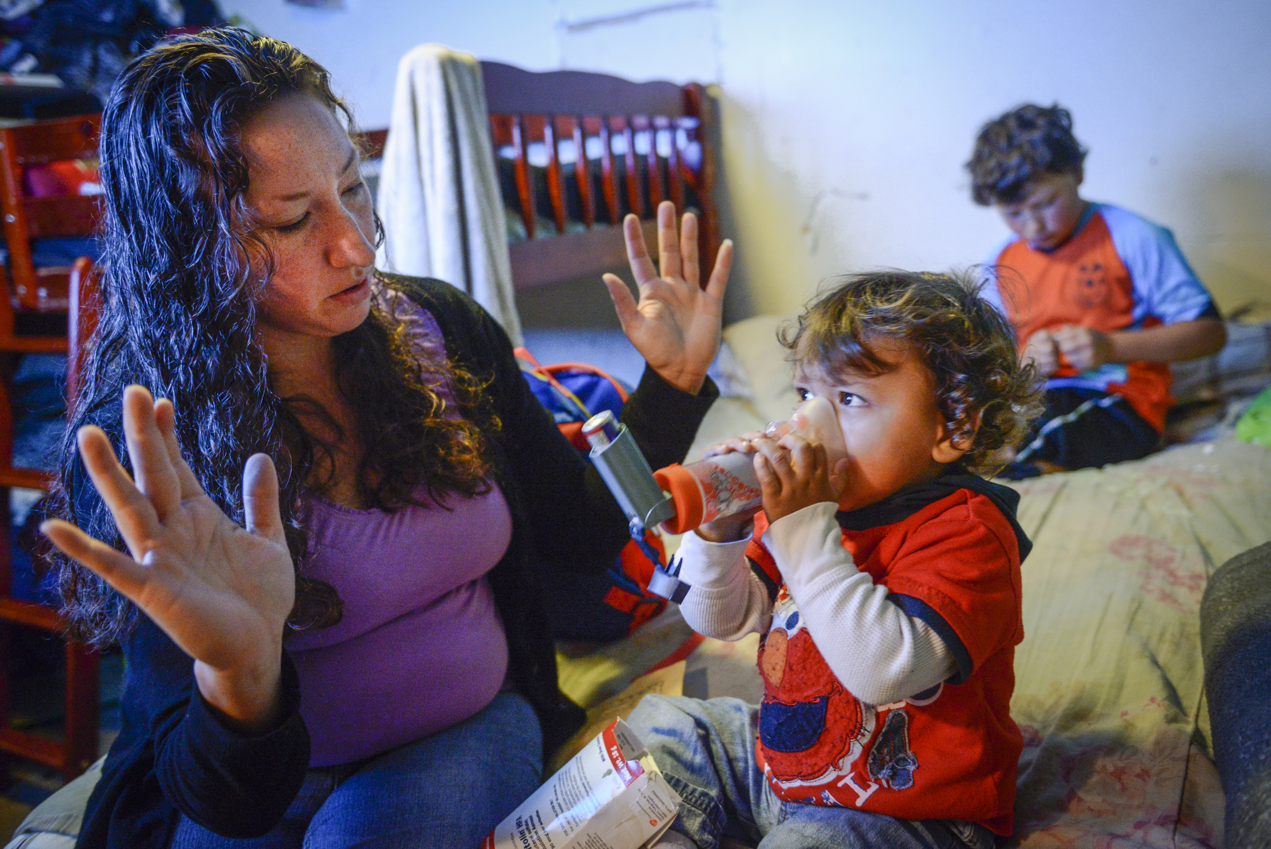  Amanda helps Dominic take his asthma medication. 