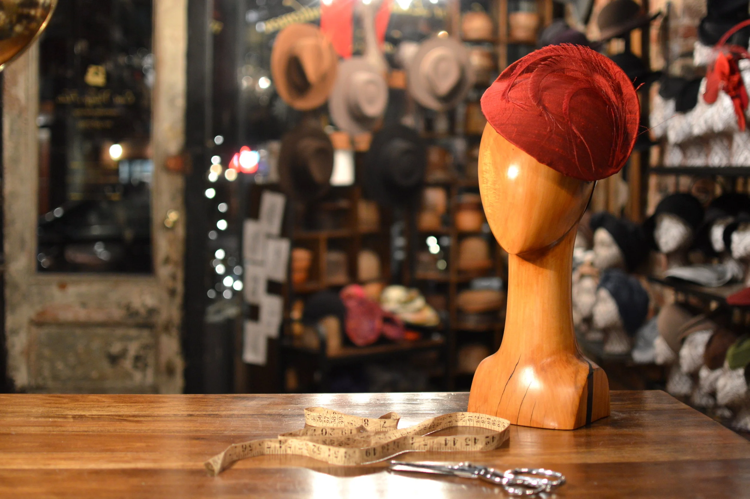 The Duchess in red silk is a lovely handmade cocktail hat with feather details