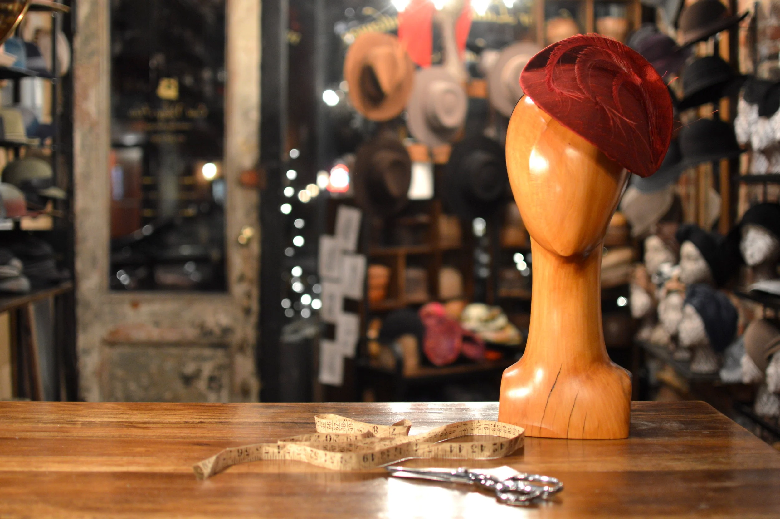 The Duchess in red silk is a lovely handmade cocktail hat with feather details