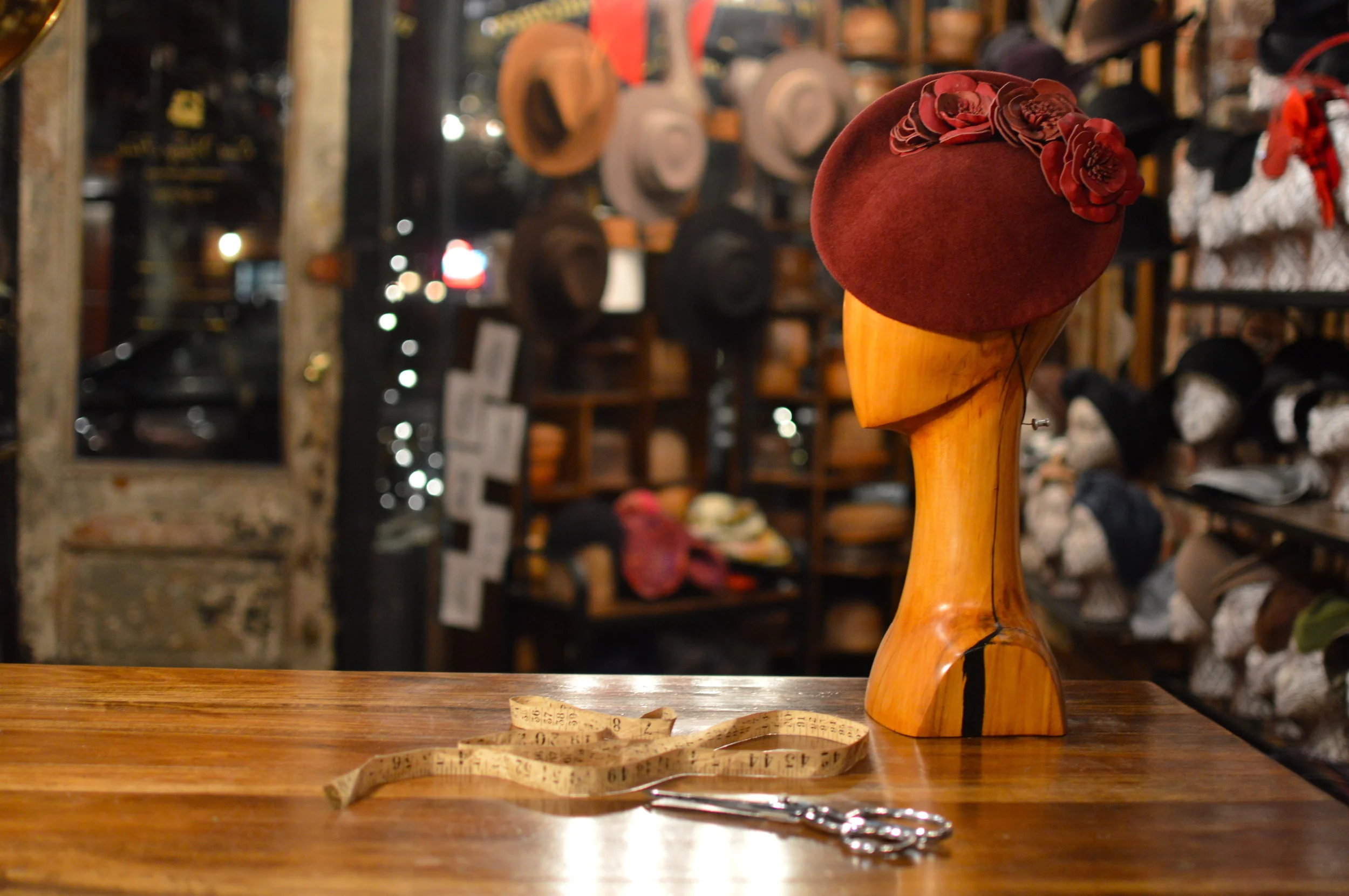 The Duchess in Scarlet is a fur felt cocktail hat with leather flower details