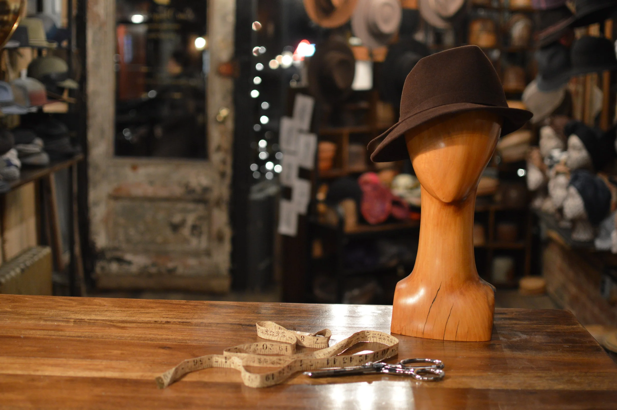 Grand Film Noir handmade in Chocolate, is a stylish asymmetrical style trimmed with a Fur Felt ribbon