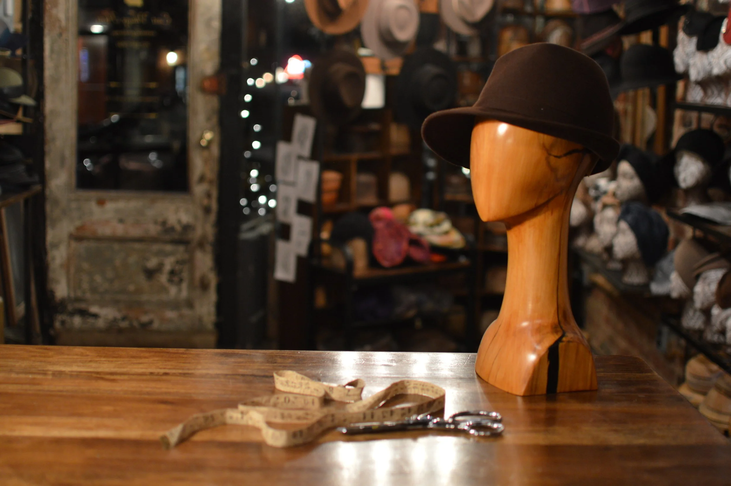 Grand Film Noir handmade in Chocolate, is a stylish asymmetrical style trimmed with a Fur Felt ribbon