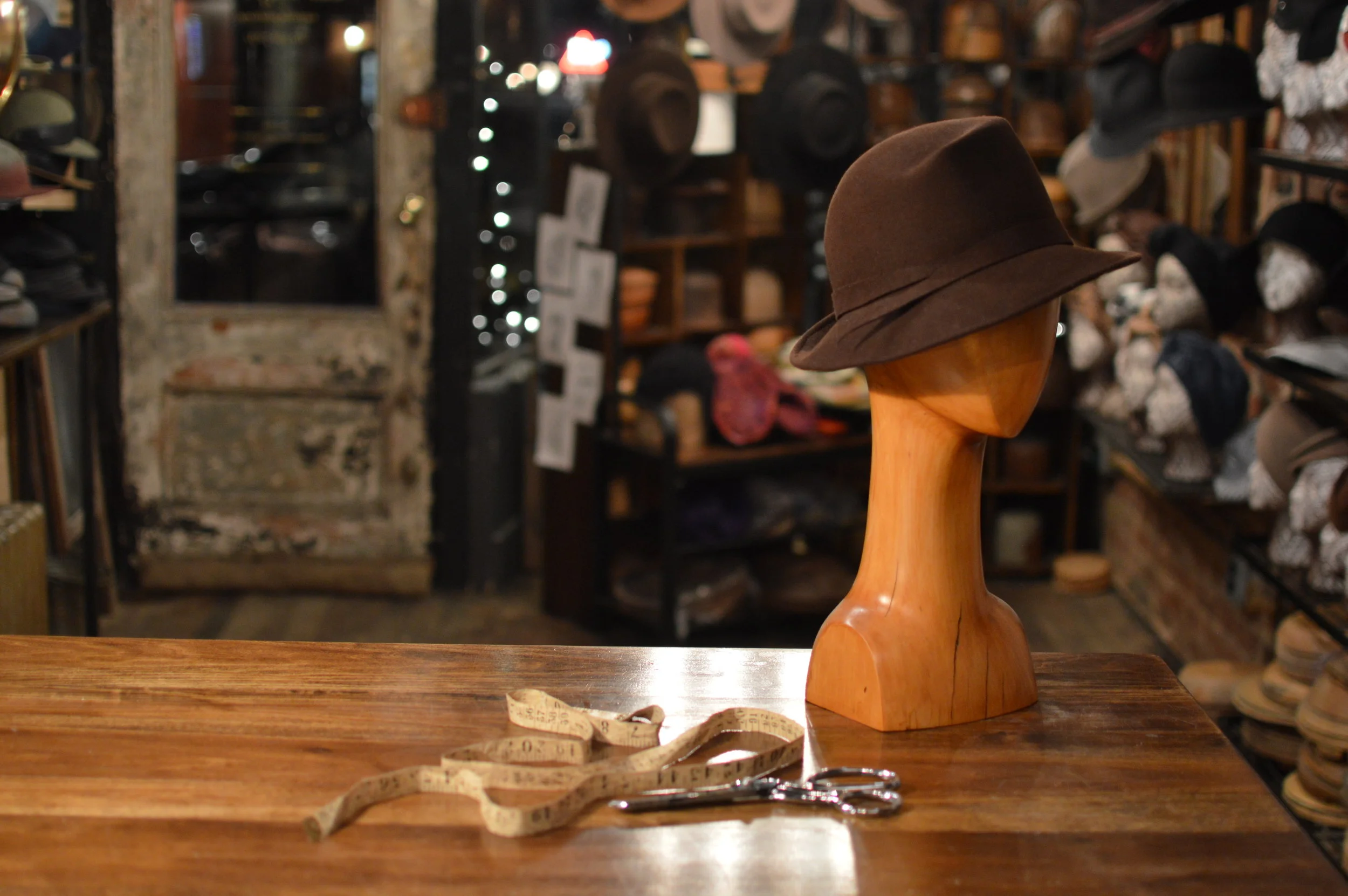 Grand Film Noir handmade in Chocolate, is a stylish asymmetrical style trimmed with a Fur Felt ribbon