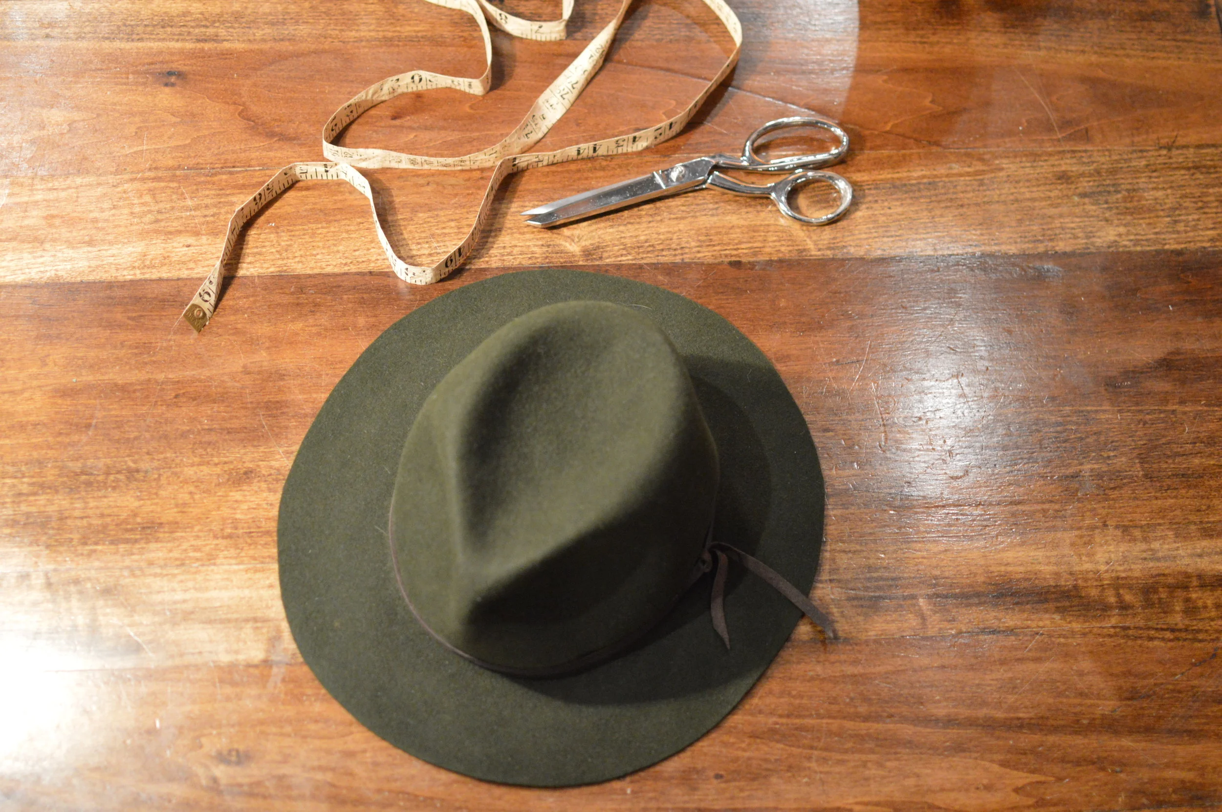 The Flat Clyde has a raw cut flat brimmed fedora handmade from Fur Felt  in rich green