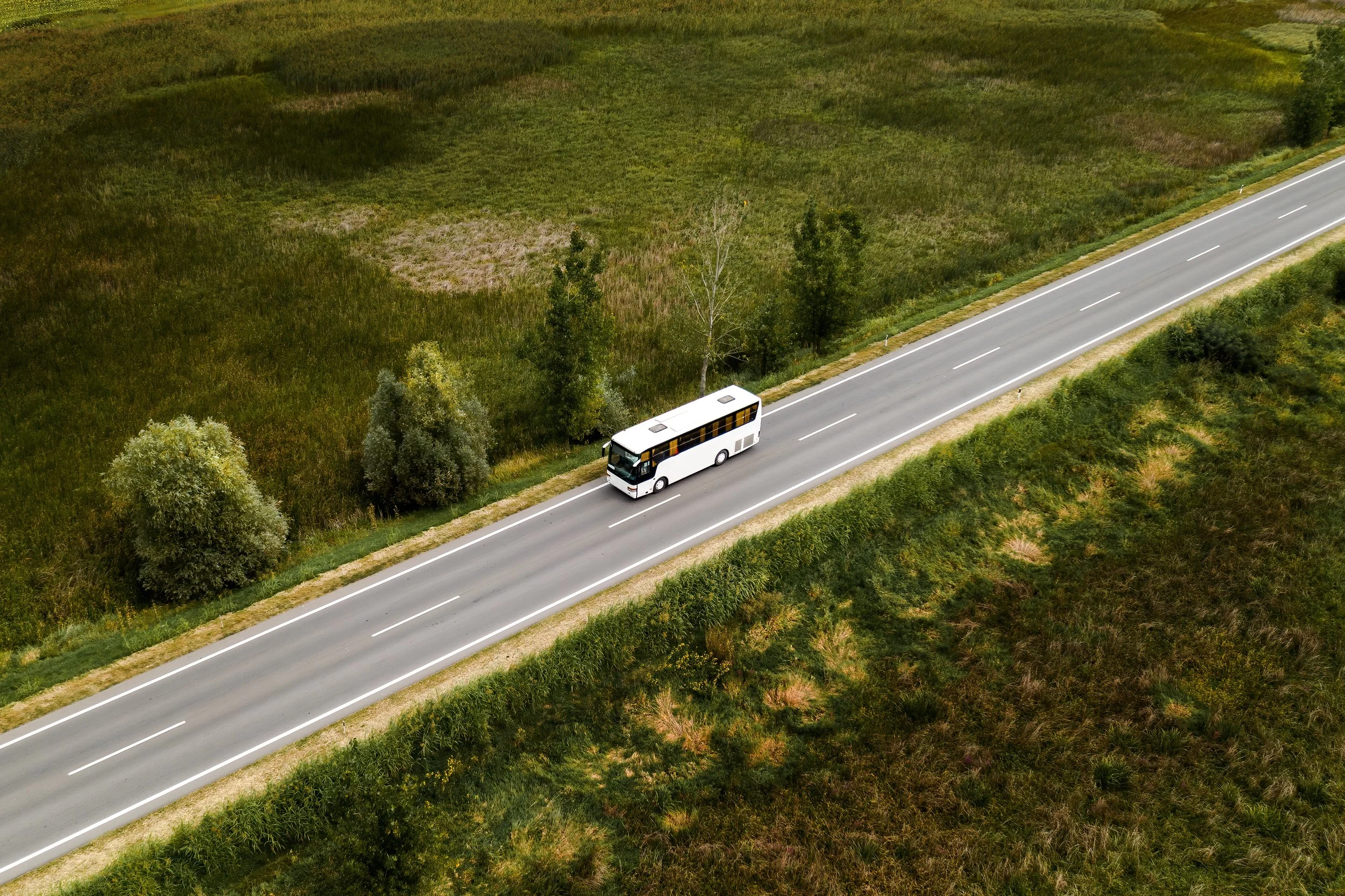 aerial-view-of-passenger-bus-on-road-through-count-2024-12-06-15-10-50-utc.jpg