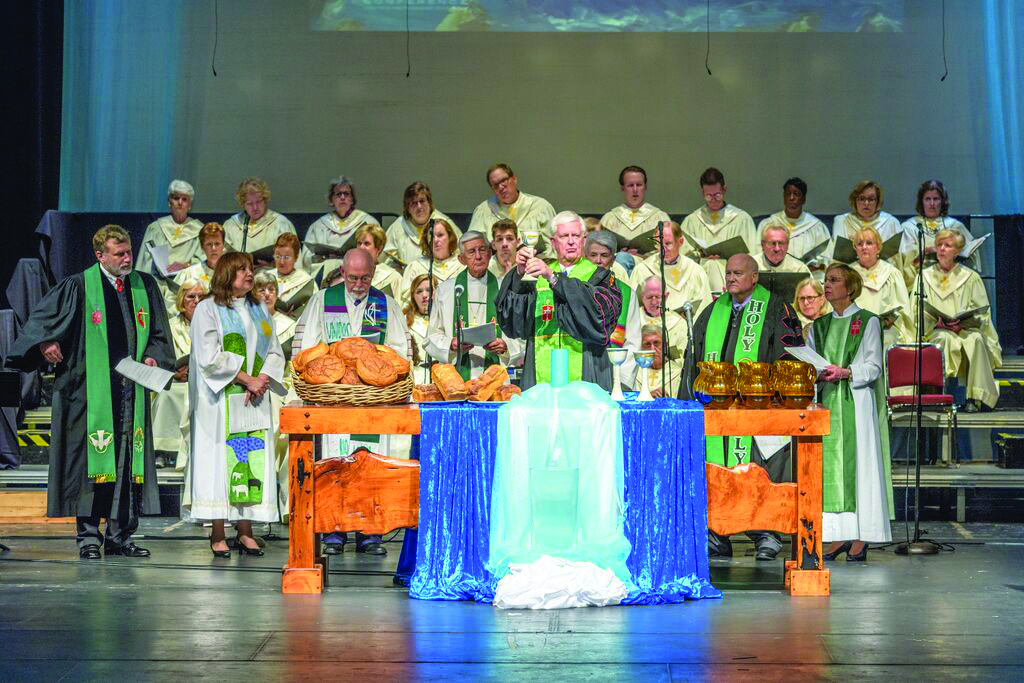 Bishops offer Communion during the Opening Word and Table Worship Service on June 11 at Selena Auditorium in Corpus Christi. Left to right: Bishop Robert Schnase, Bishop Minerva Carcaño, Bishop Joel N. Martinez, Bishop Dan E. Solomon, Bishop James D…