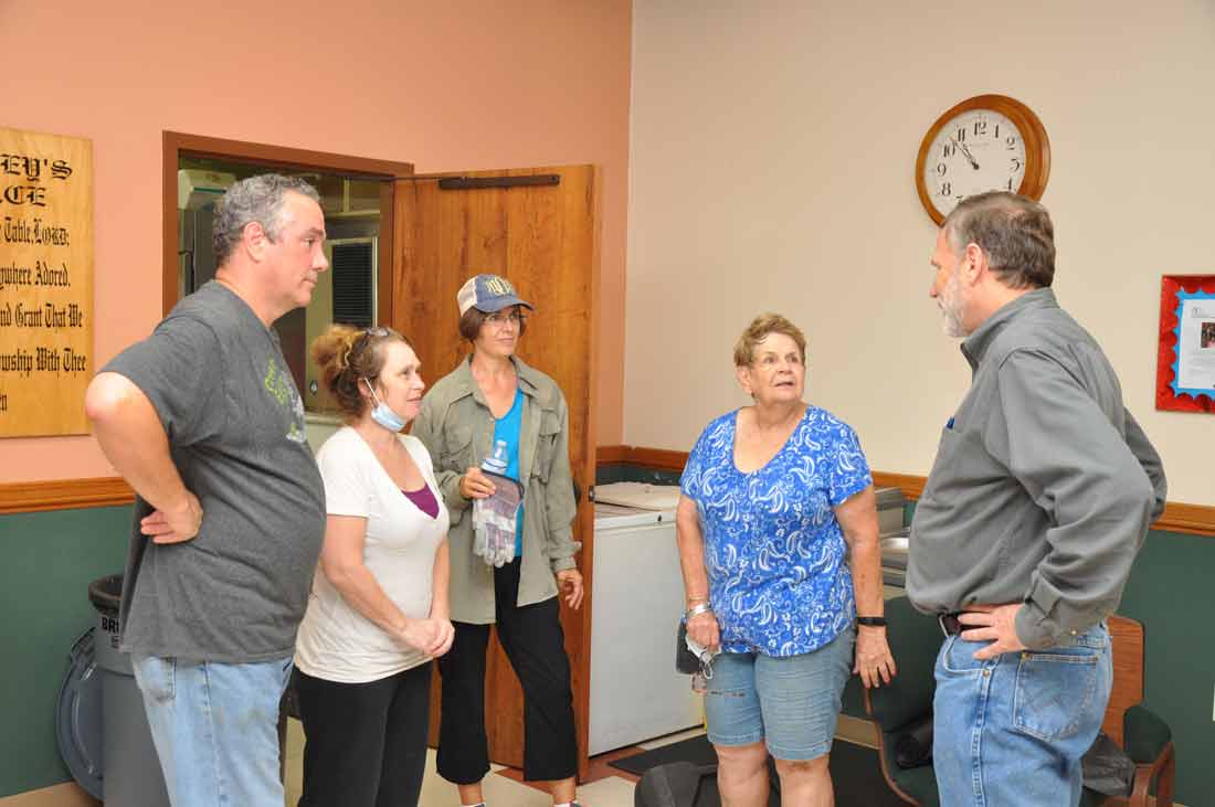 ROBERT SCHNASE, BISHOP OF THE RIO TEXAS CONFERENCE ASSESSES DAMAGE AT FIRST UMC PORTLAND WITH MEMBERS AND VOLUNTEERS.