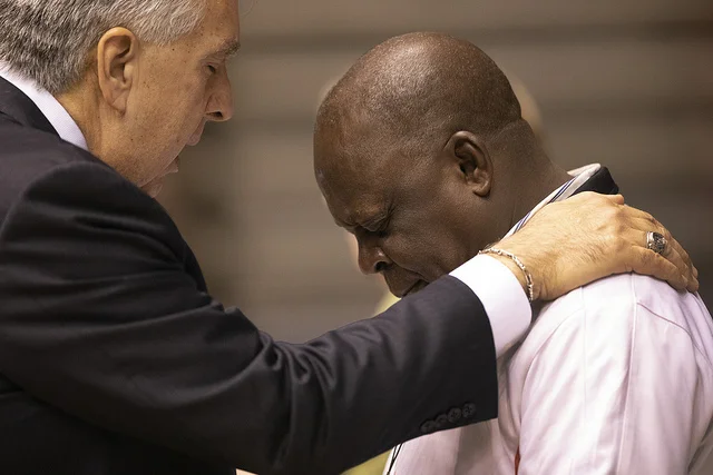 Bishop Ruben Saenz prays with Luka Bitrus, delagate from Southern Nigeria, during the 2019 Special Session of the United Methodist General Conference in St. Louis. Photo by Kathleen Barry, UMNS.
