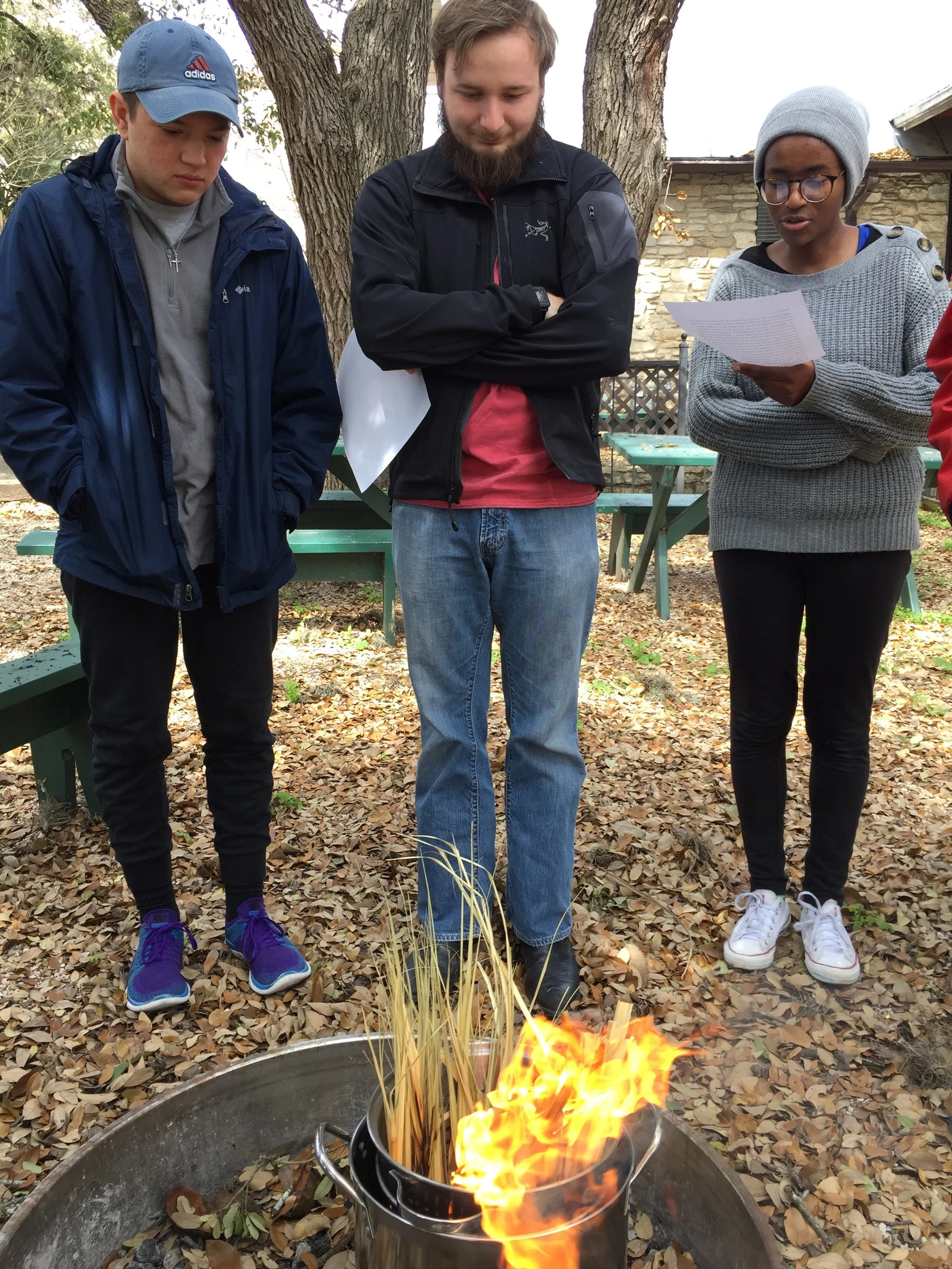 Texas State UCM students Evan Perez, Walker Metyko, and Consolatrice Nzoya prepare ashes from last year’s palms.