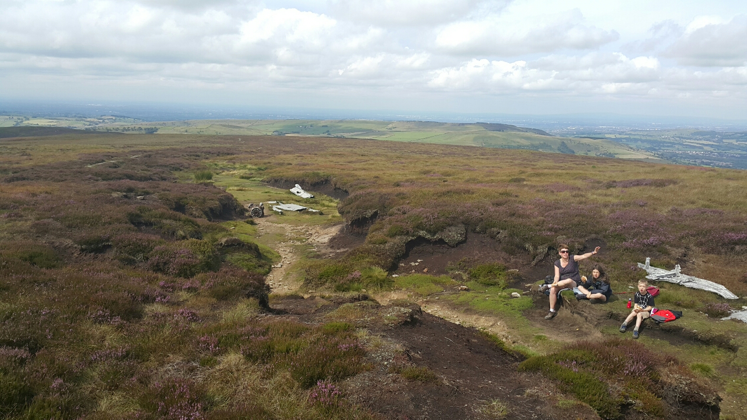 A family having a snack amongst the wreckage of a WW2 US superfortress bomber that crashed on the moors.