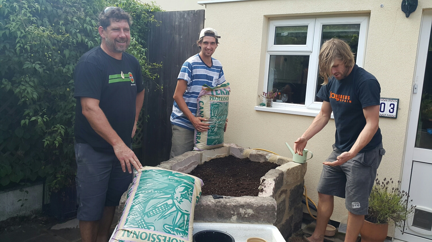 Ben doing all the Hard work filling in Wyns new Herb garden. Pete not sure what the brown stuff is on his hands