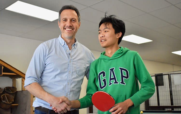 Dr. Gowers demonstrating sportsmanship after defeat by the reigning champion, Alan, on the way to the finals.