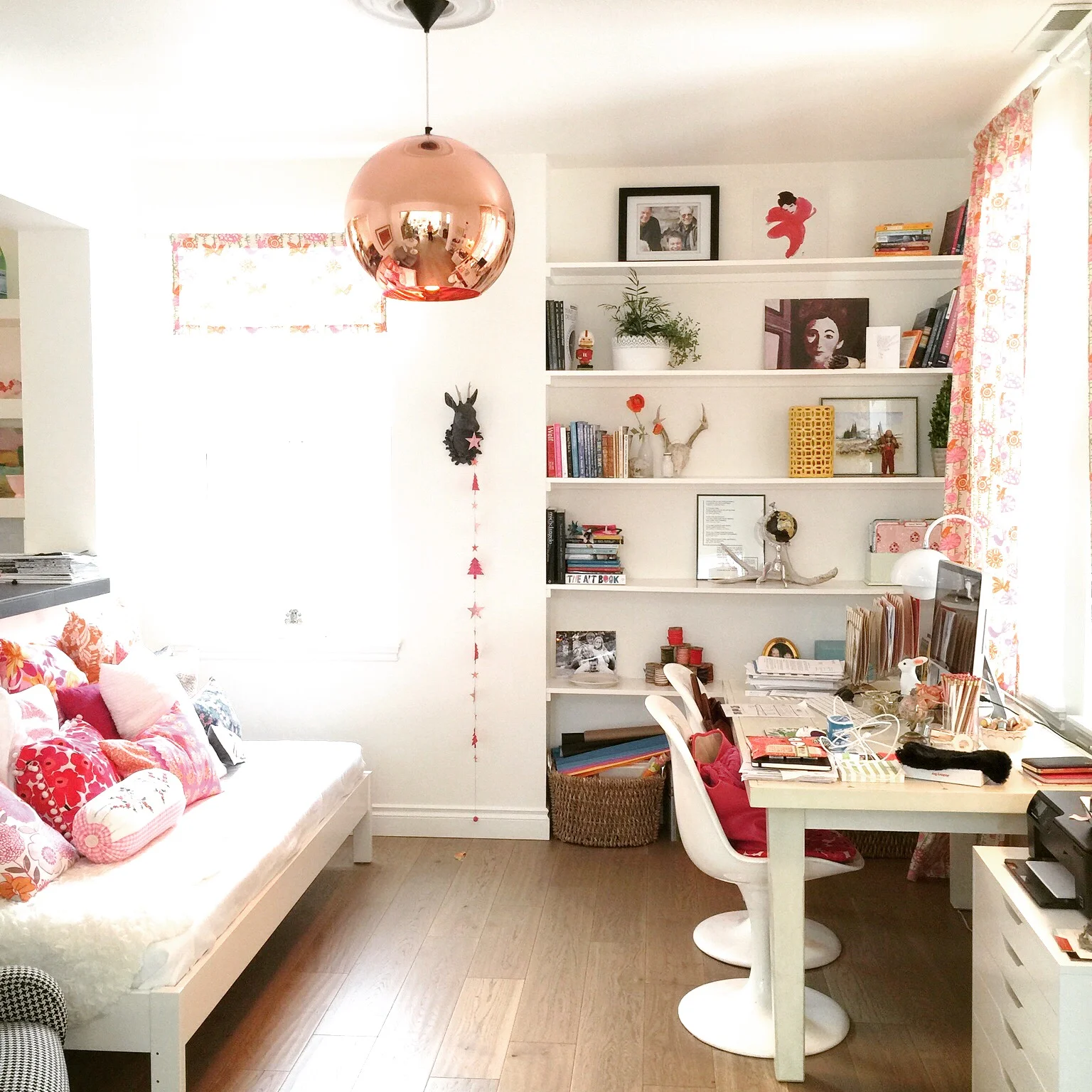 Kristen Meckem Travel office: featuring Tom Dixon copper pendant light , European oak floors, vintage desk lamp, She's Happy pillows and Marco Zanuso Lady Chair .
