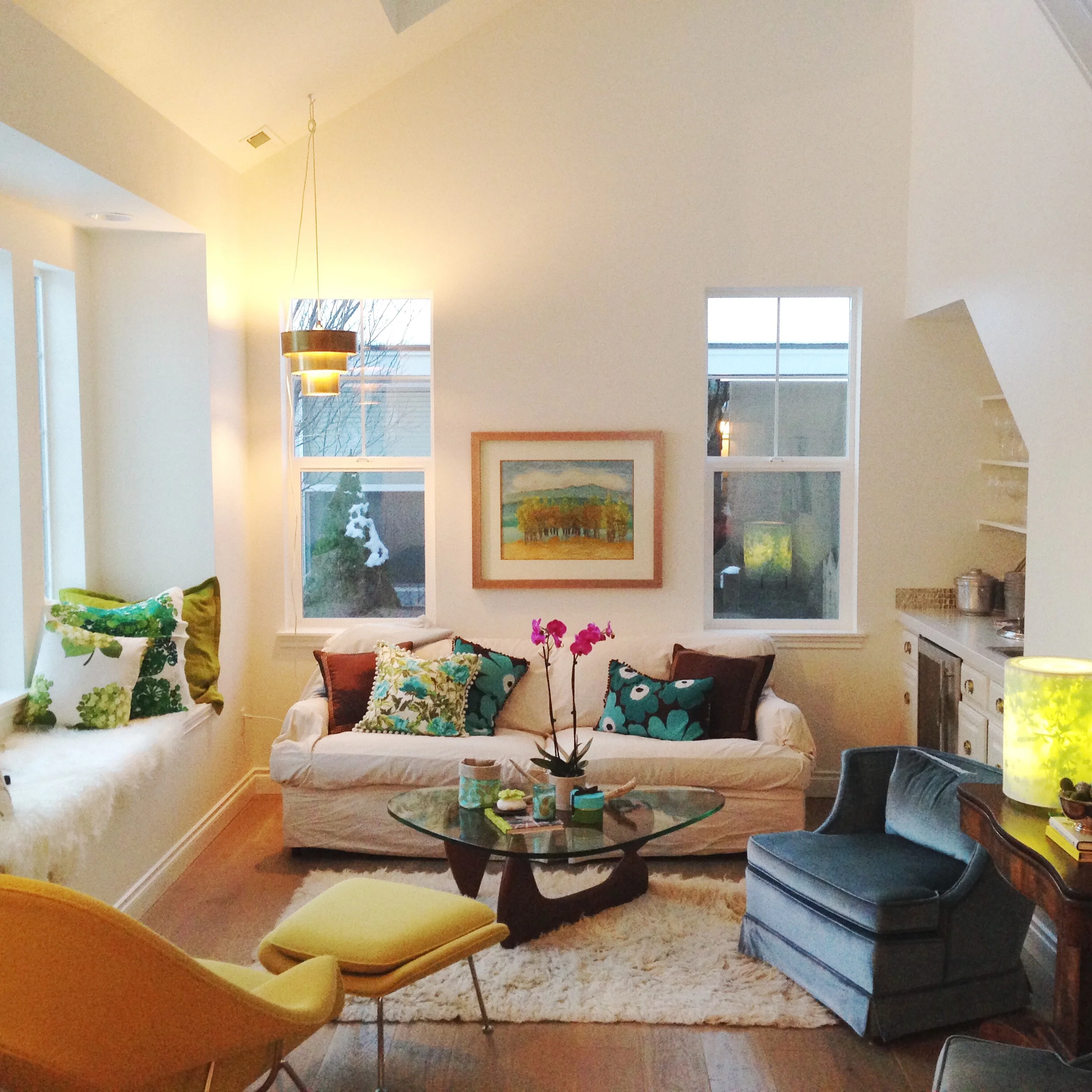My living room: featuring Eero Saarinen Womb Chair , Tord Boontje light , vintage velvet chairs, Marimekko , vintage scandinavian and Amy Butler fabrics, Flokati rug, She's Happy Design and Tuuli Design Co pillows, and antique English pulls.
