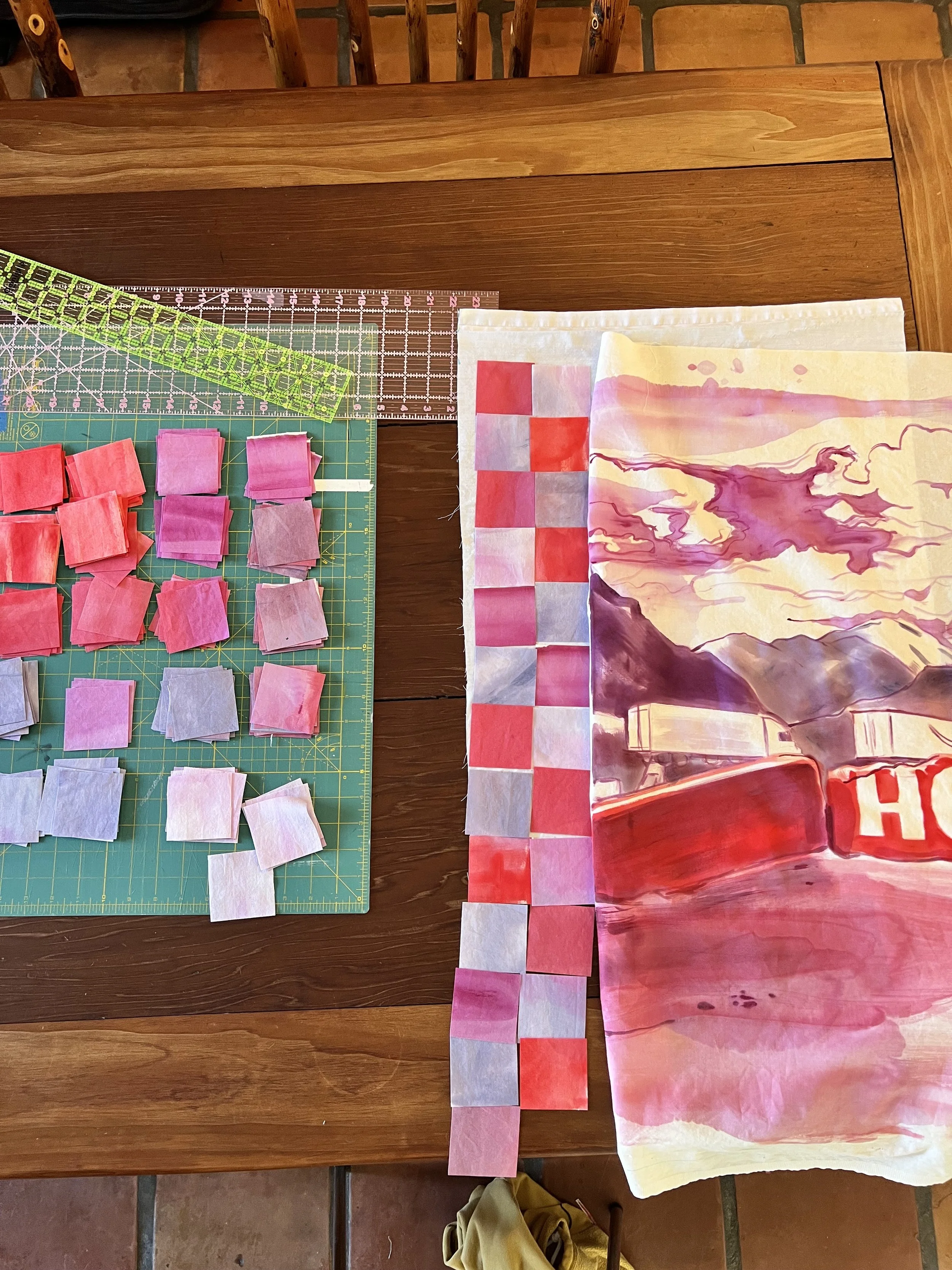 Hand painted squares laid out ready to sew