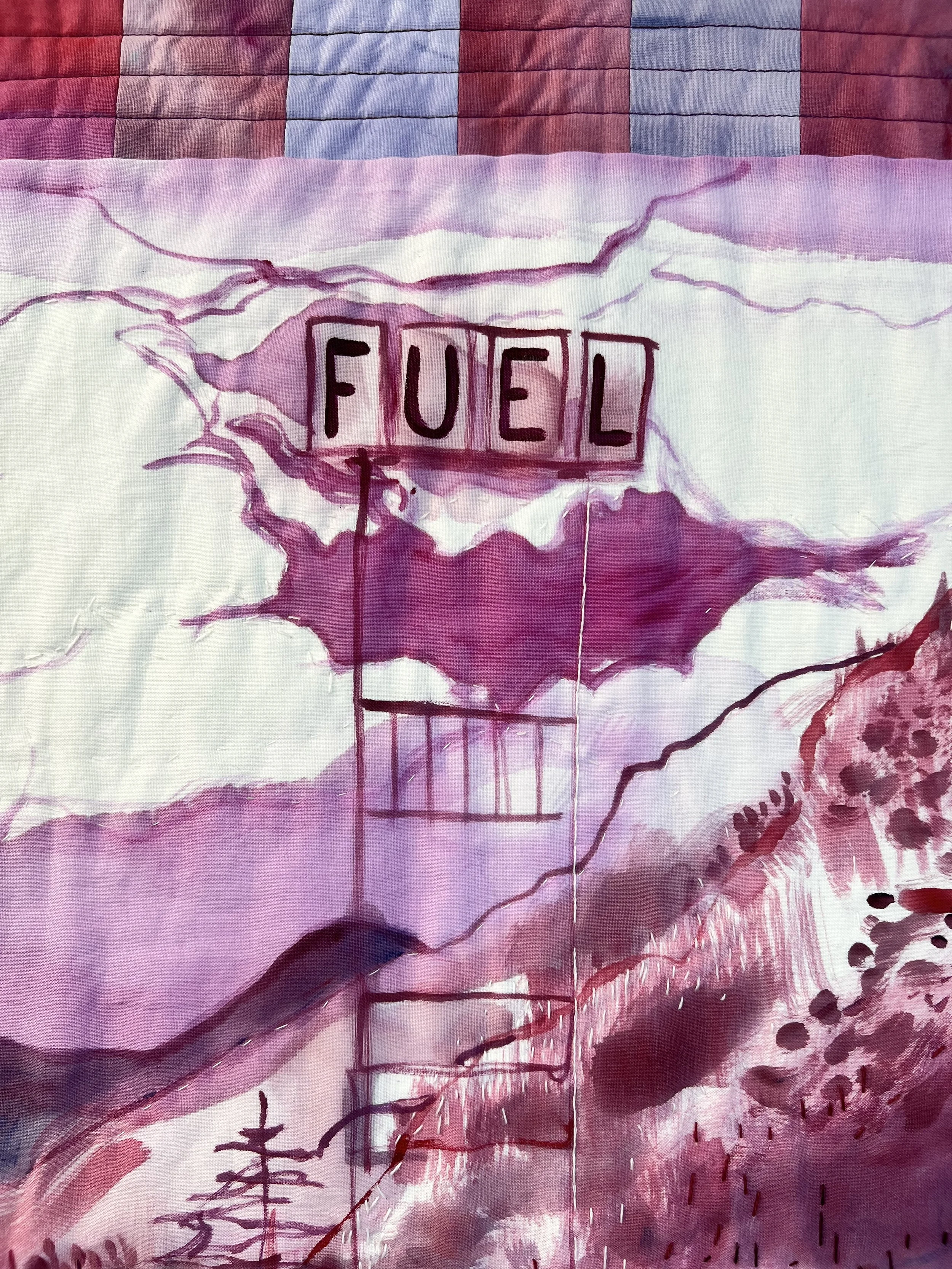 Detail of painted and embroidered sky area and fuel sign