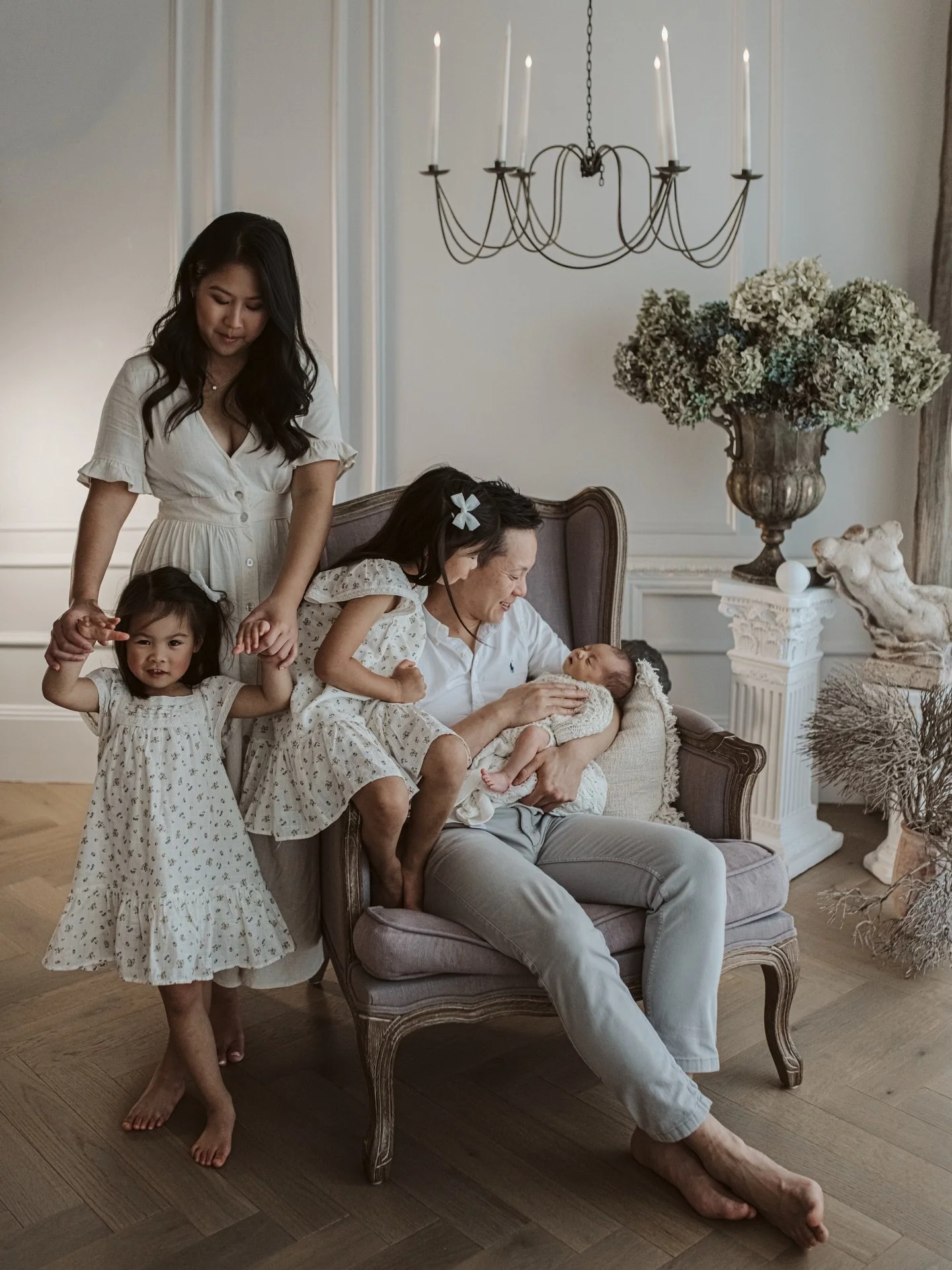 There&rsquo;s something so quietly beautiful about this image&hellip;

Dad and the youngest daughter completely wrapped up in the wonder of the newest little addition, while mum and the eldest stand close by - simply present, hand in hand, taking it 