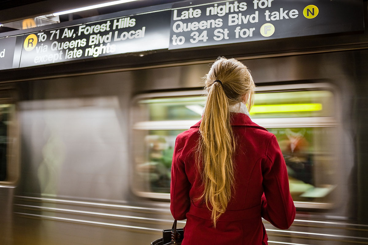 Blonde girl in a red coat, Subway, New York
