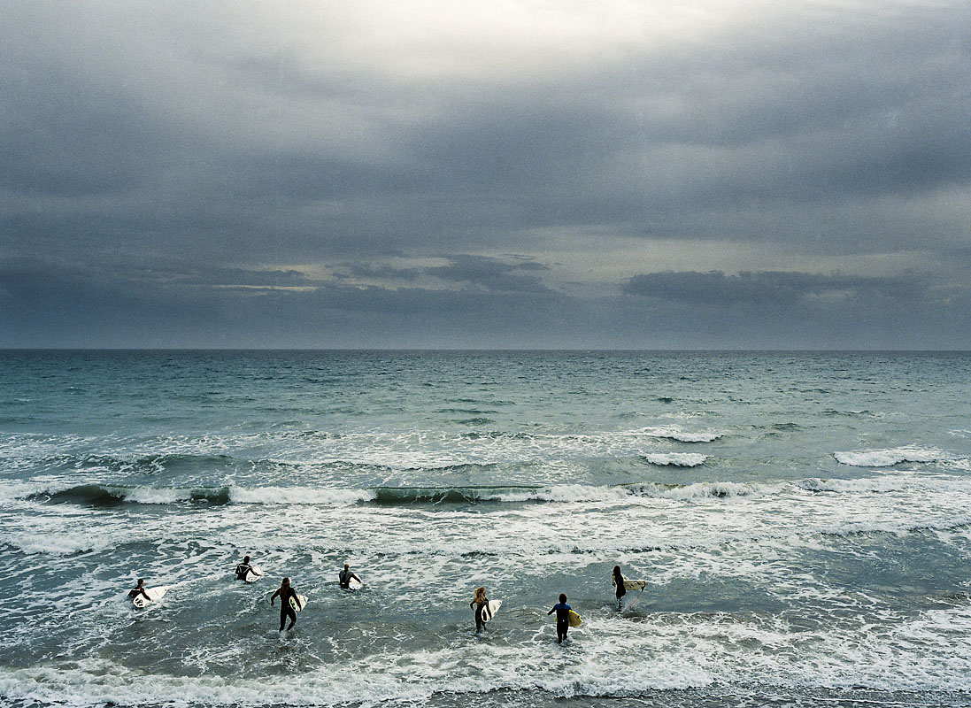 Surfers on a stormy day, Spain