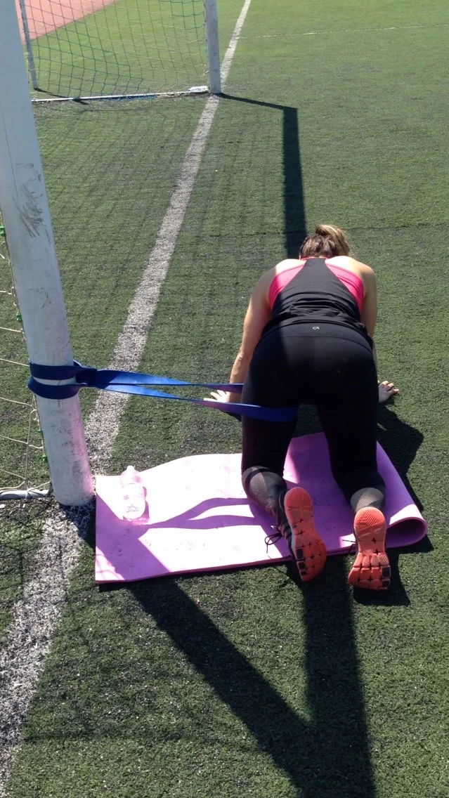 Band assisted hip internal rotation mobilisation.