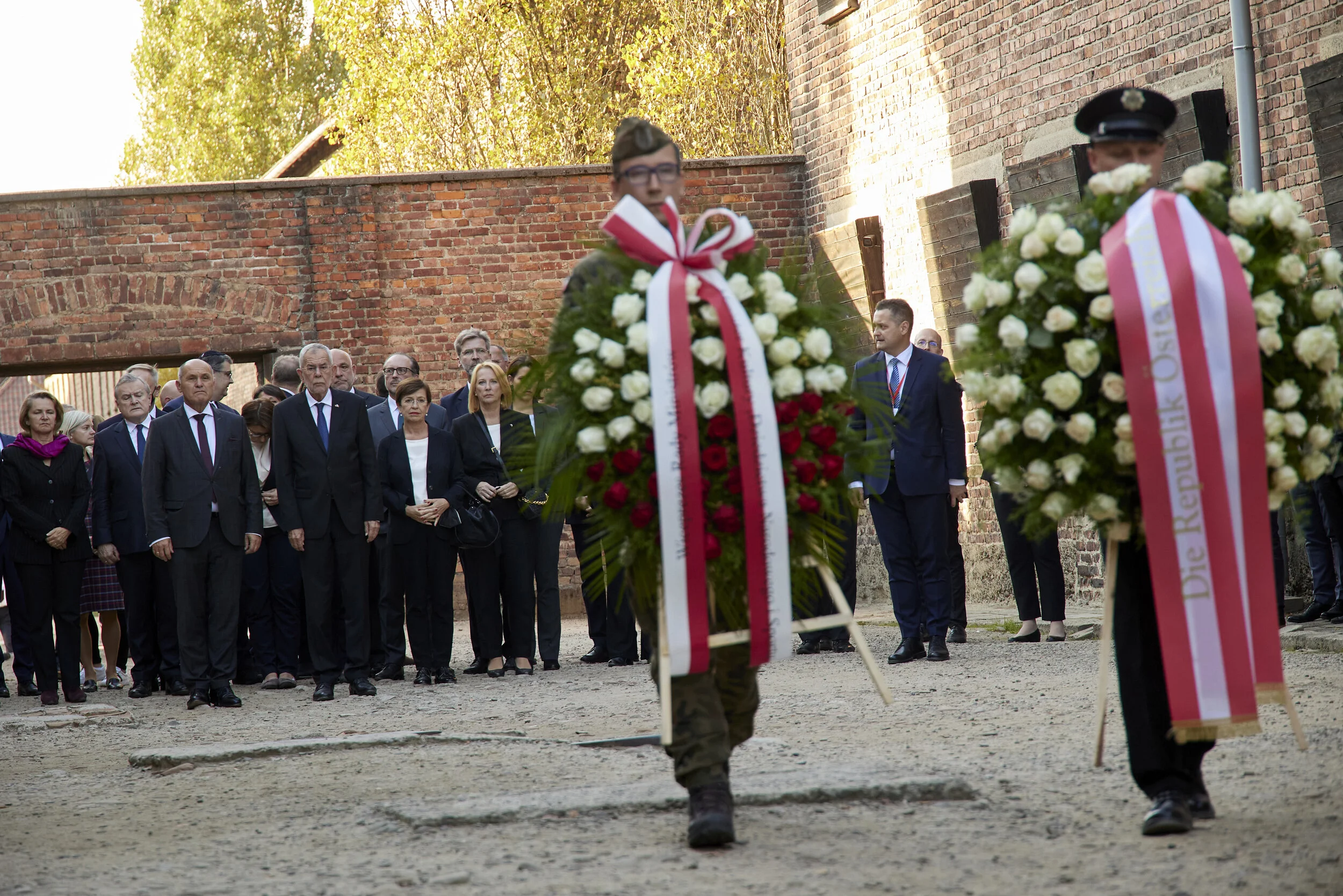 Wreath laying ceremony at the “Black Wall” execution site.