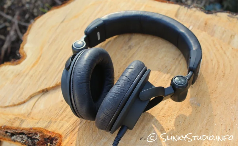 Ultrasone Signature Pro Headphones Lying on Cut Log.jpg
