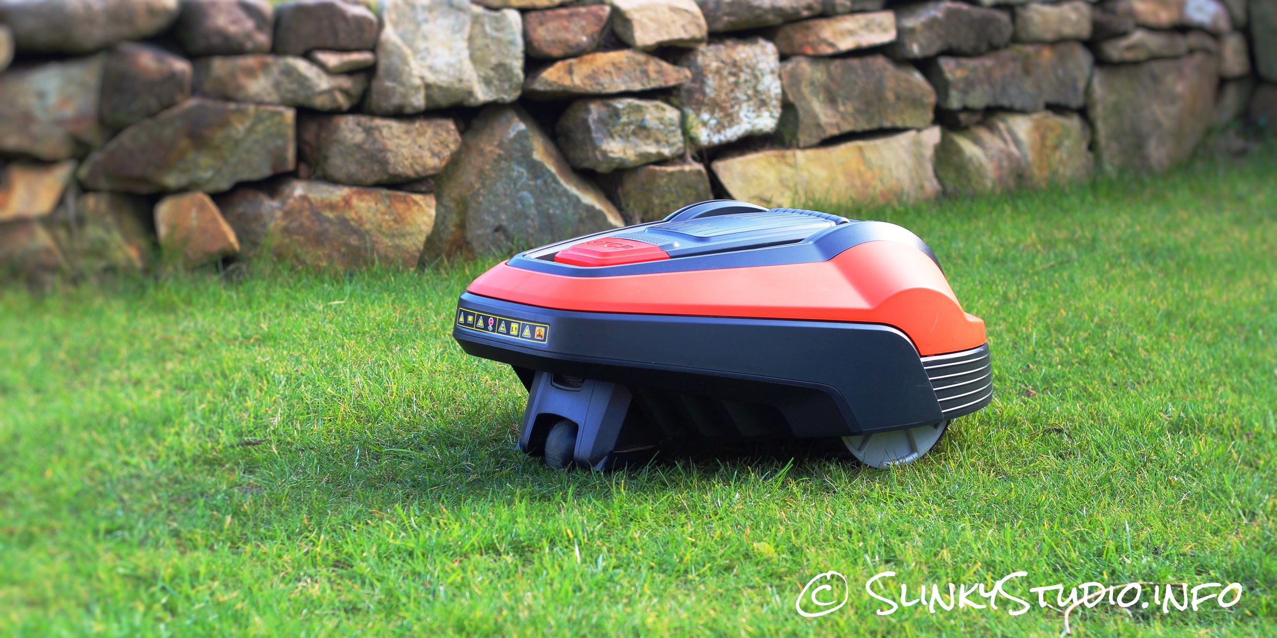 Flymo Robotic 1200R Lawnmower Mowing Lawn Side View.jpg