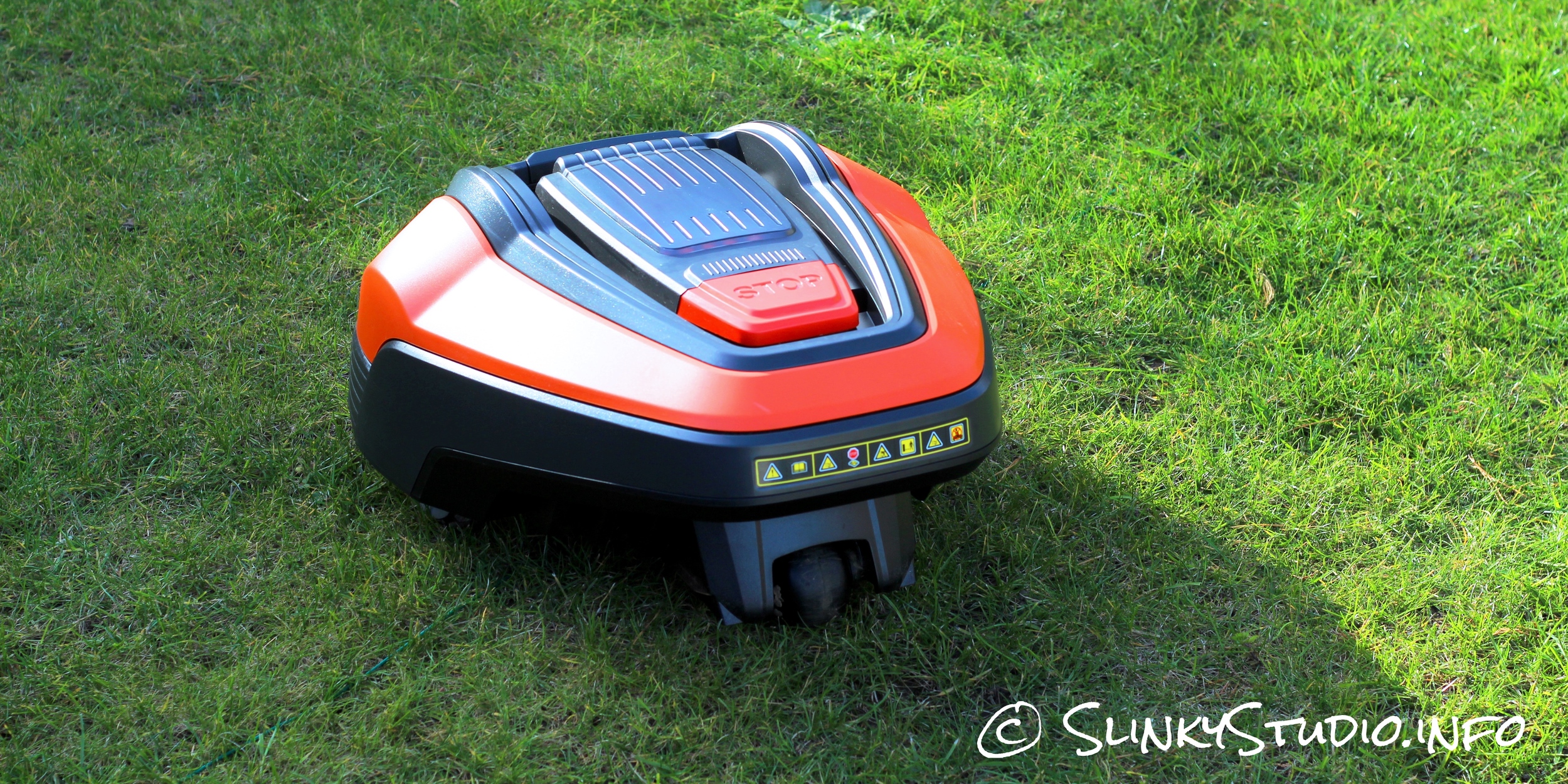 Flymo Robotic 1200R Lawnmower Mowing Lawn Above Back View.jpg