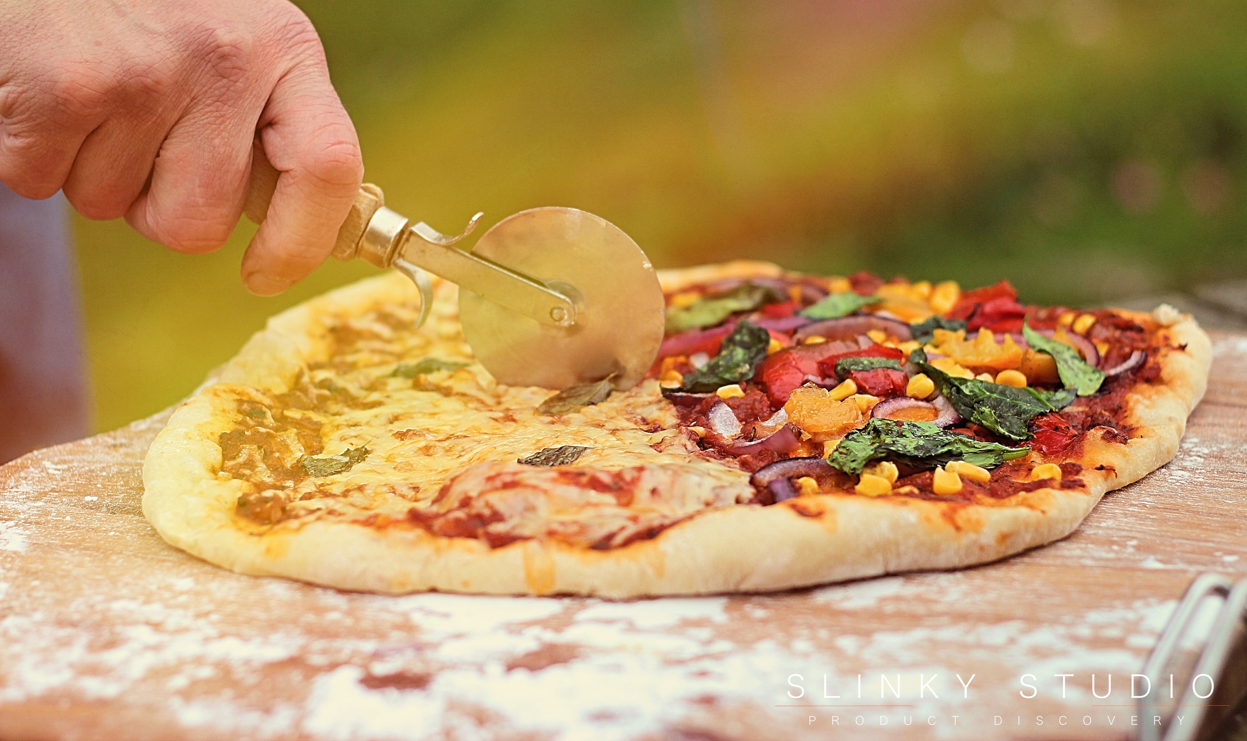 Grenadier Earth Fire Pizza Oven Slicing Cooked Pizza.jpg