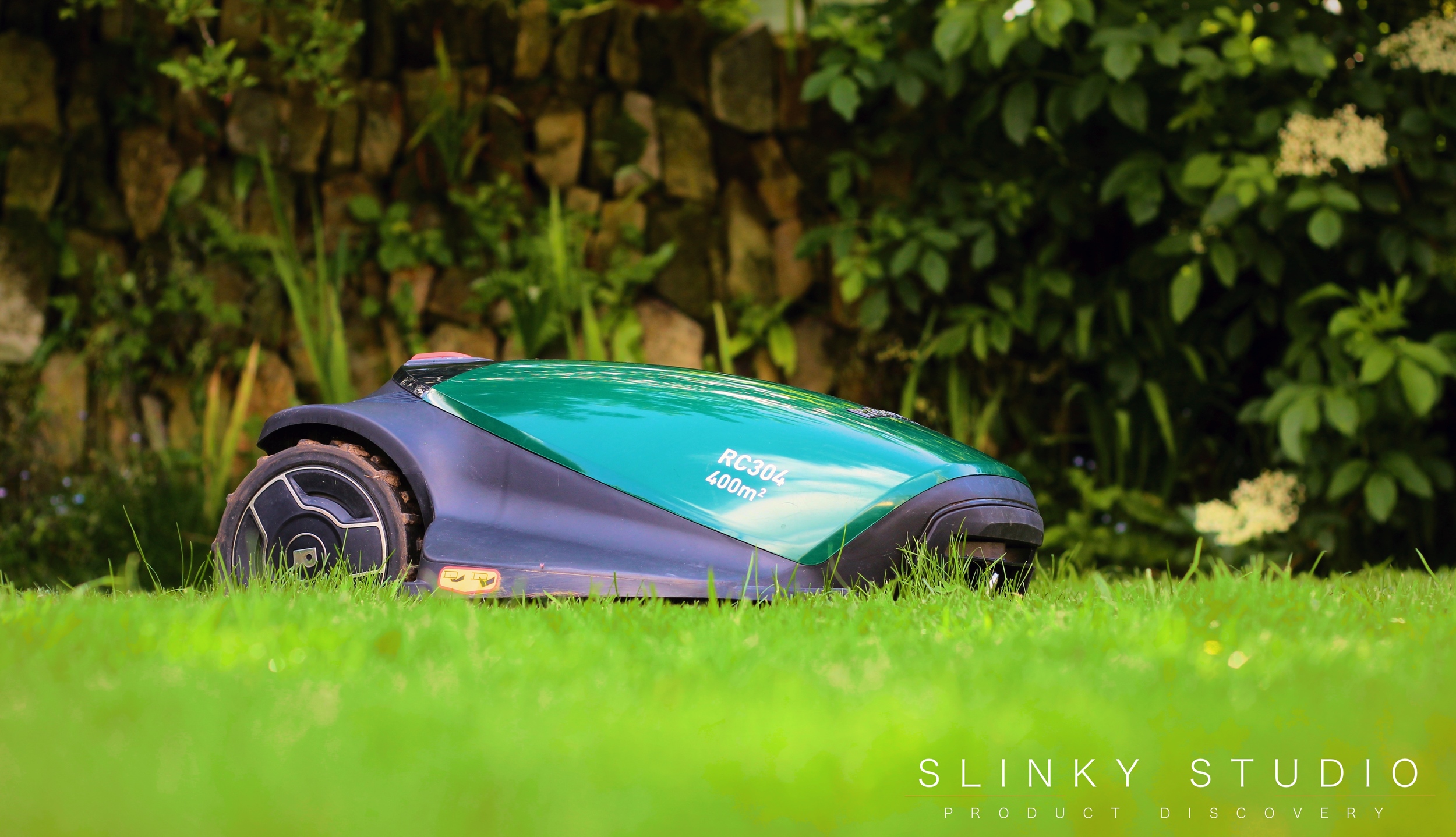 Robomow RC304 Robot Lawnmower Mowing Lawn Side View.jpg