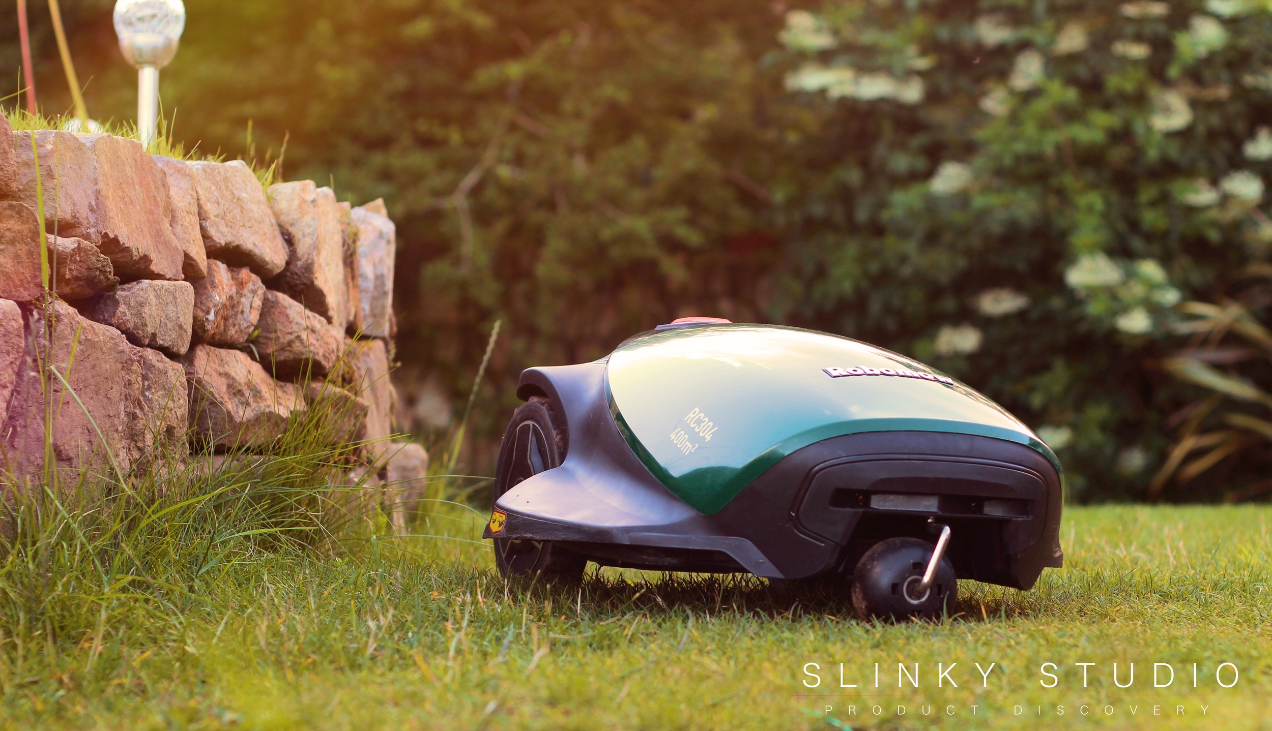 Robomow RC304 Robot Lawnmower Mowing Around Wall Edge.jpg