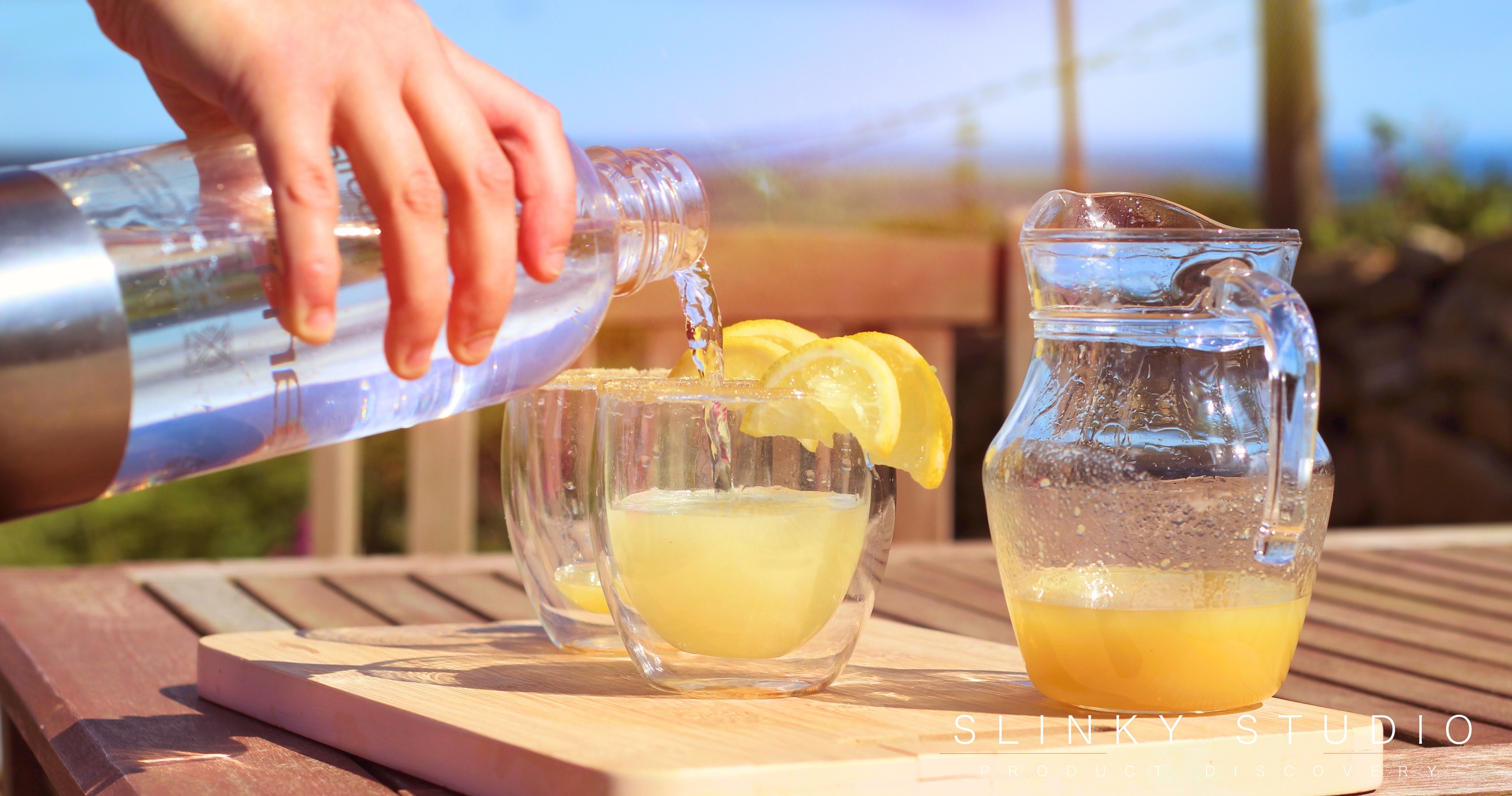 Optimum ThermoCook Ginger Beer SodaStream Being Poured On Bench in Sun.jpg