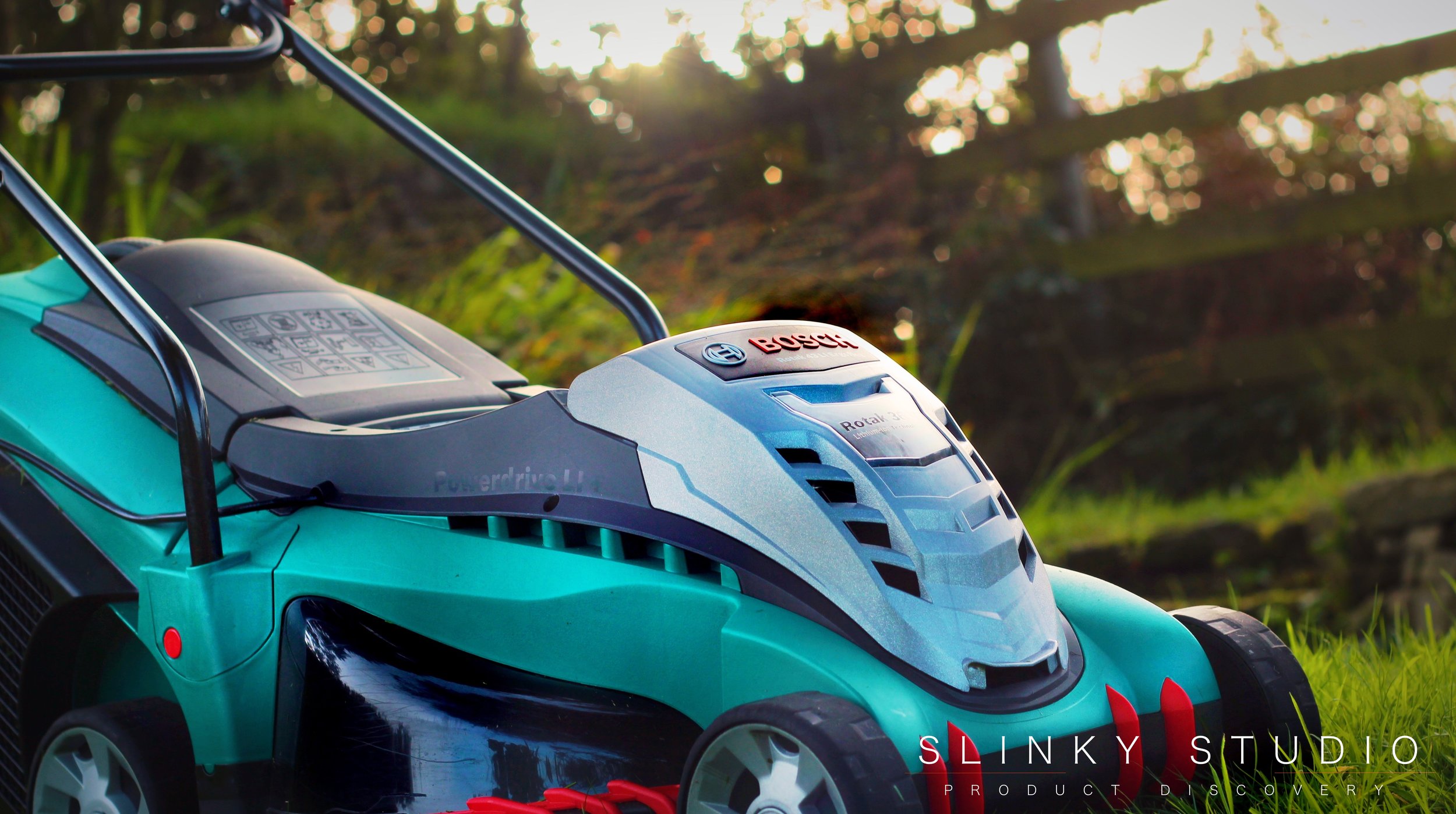 Bosch Rotak 43 LI Ergoflex Cordless Lawnmower Dusk Lighting Through Fence.jpg