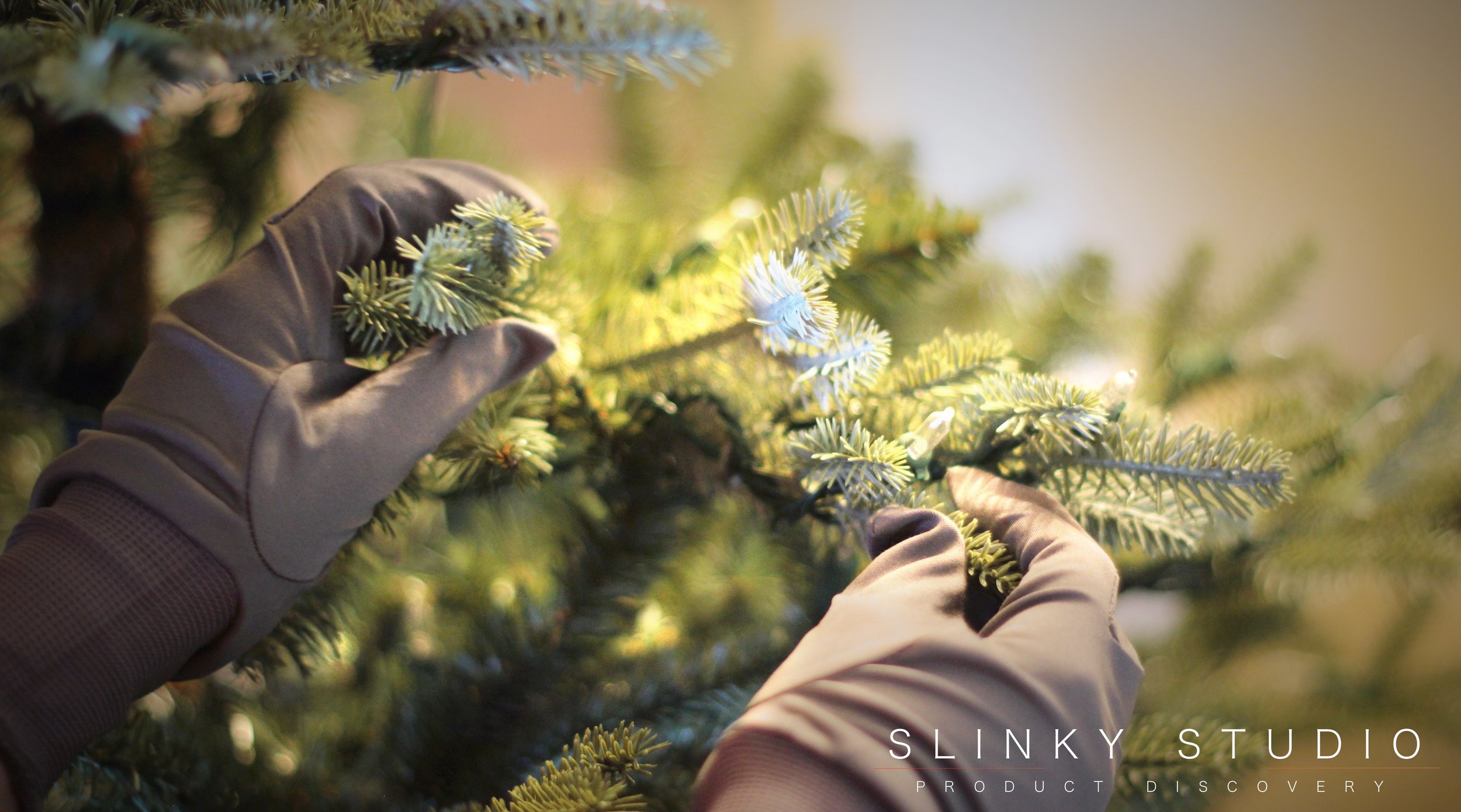 Balsam Hill Fraser Fir Christmas Tree Shaping Branches with Gloves on.jpg