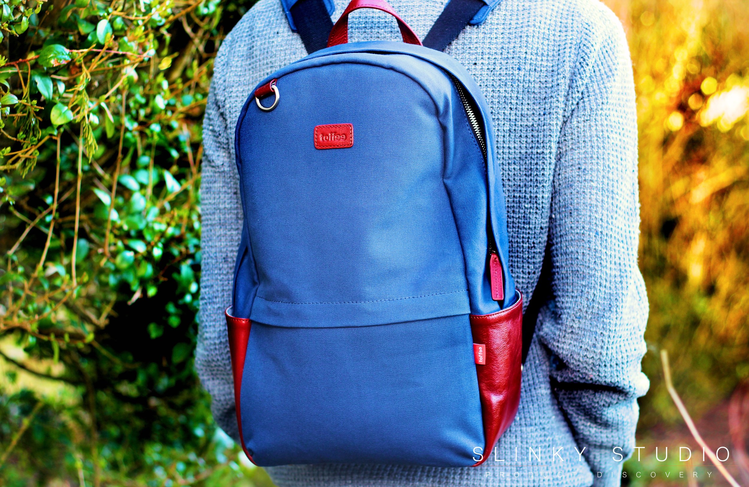 Toffee Berlin Backpack Navy Blue wearing through woodland.jpg