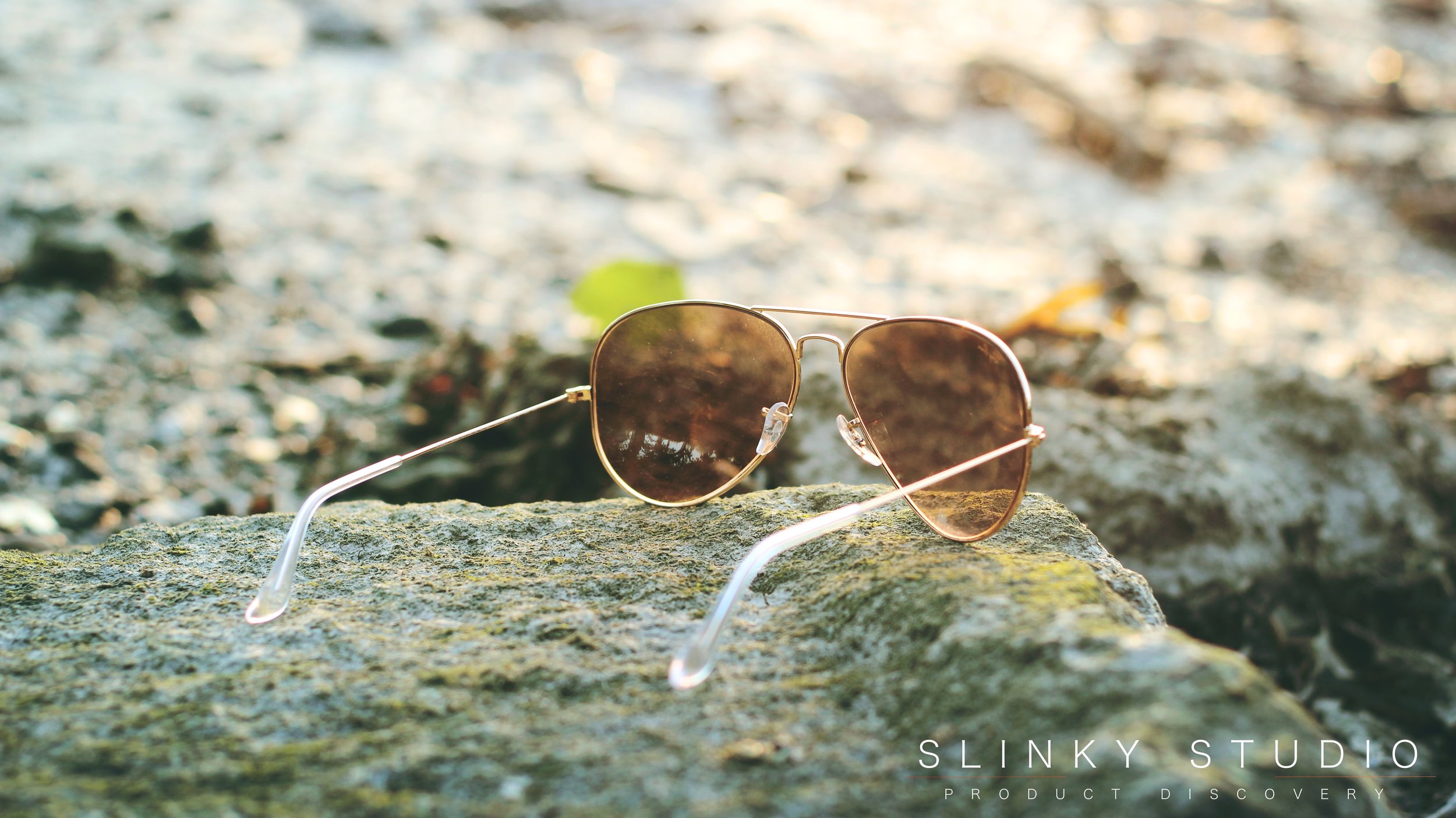 Ray Ban Aviator Sunglasses RB3025 Resting on Stone at Beach.jpg