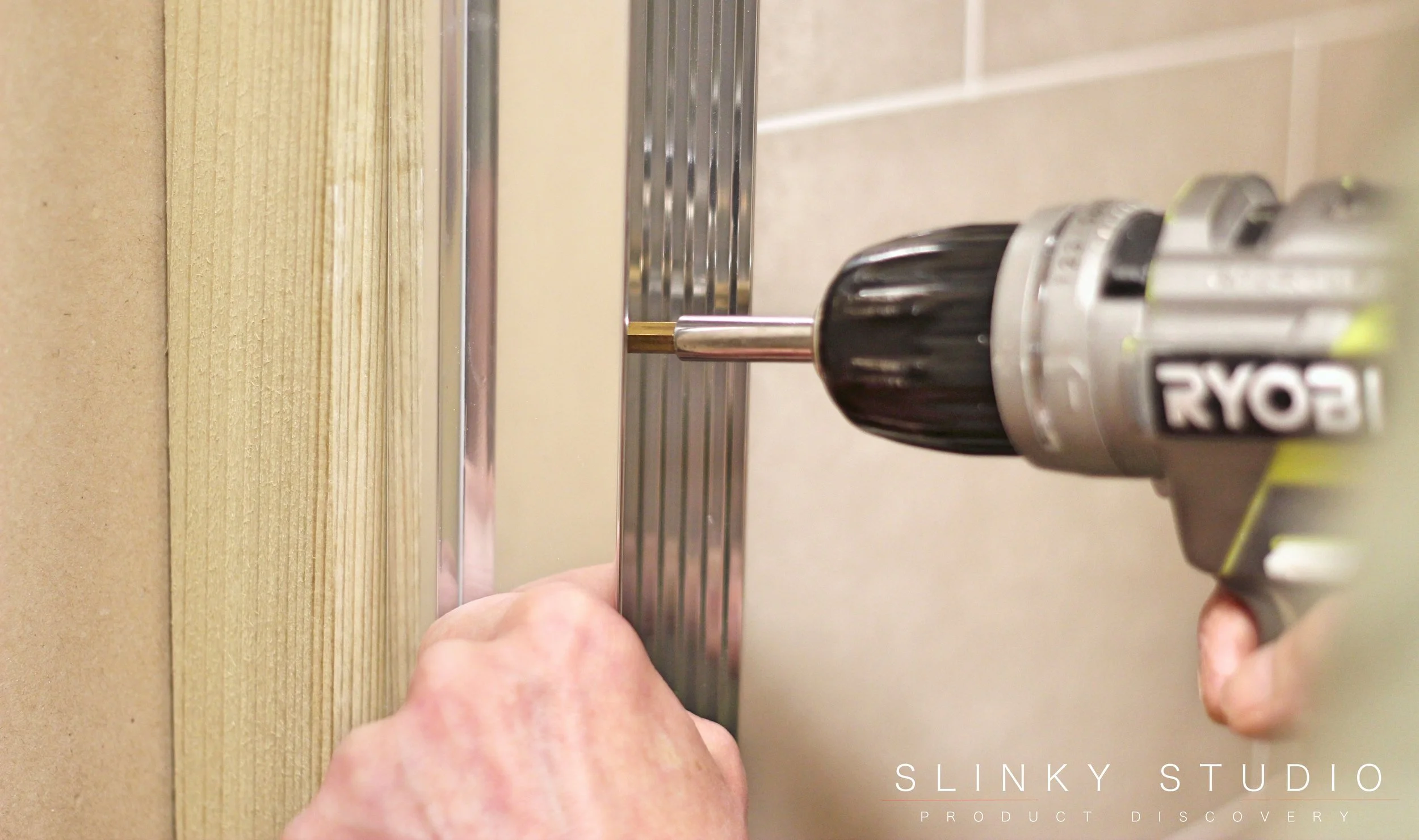 Mira Leap Quadrant Shower Installing Frame onto wall.jpg
