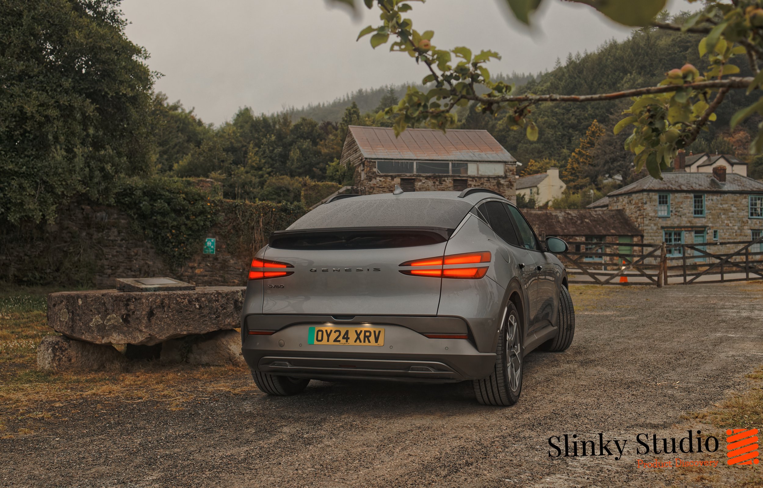 Genesis GV60 Behind View driving into Cornish village atmospheric.jpg