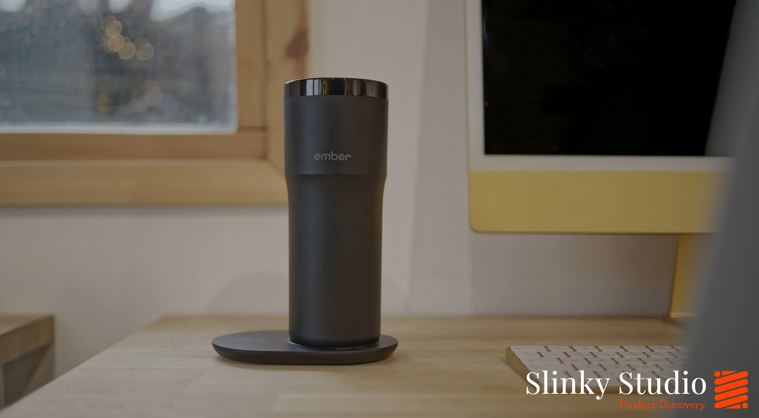 Ember Travel Mug 2+ charging coaster on desk.jpg