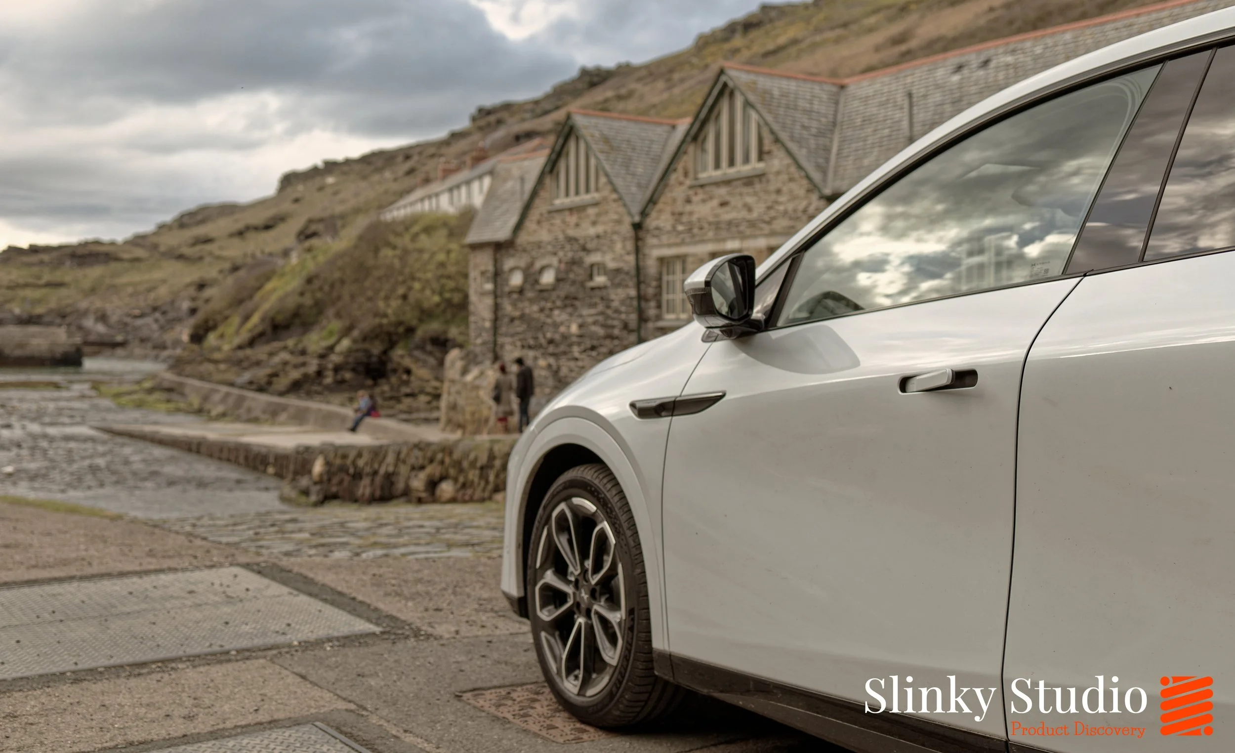 XPENG G6 Arctic White Driving Cornwall Coastal Town Dock.jpg