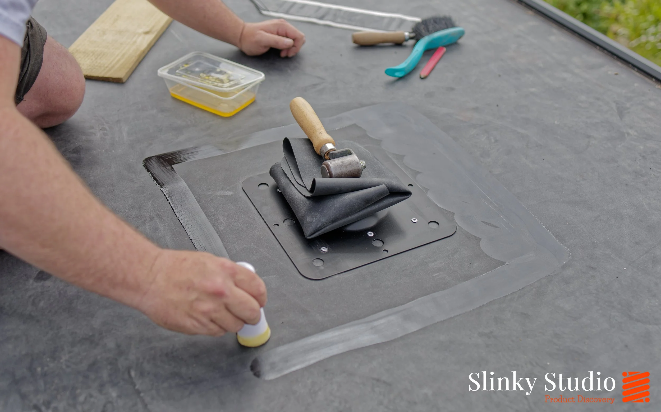 Nicholson ROOFTRAK IFP250 Adhesive Being Applied to EPDM Membrane Flat Roof Installation.jpg