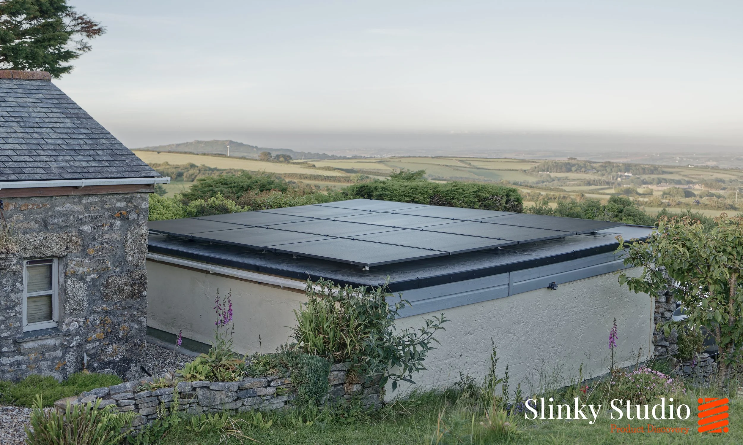 Nicholson ROOFTRAK IFP250 Solar PV Panels on EPDM Rubber Membrane Flat Garage Roof Overlooking in Cornwall.jpg