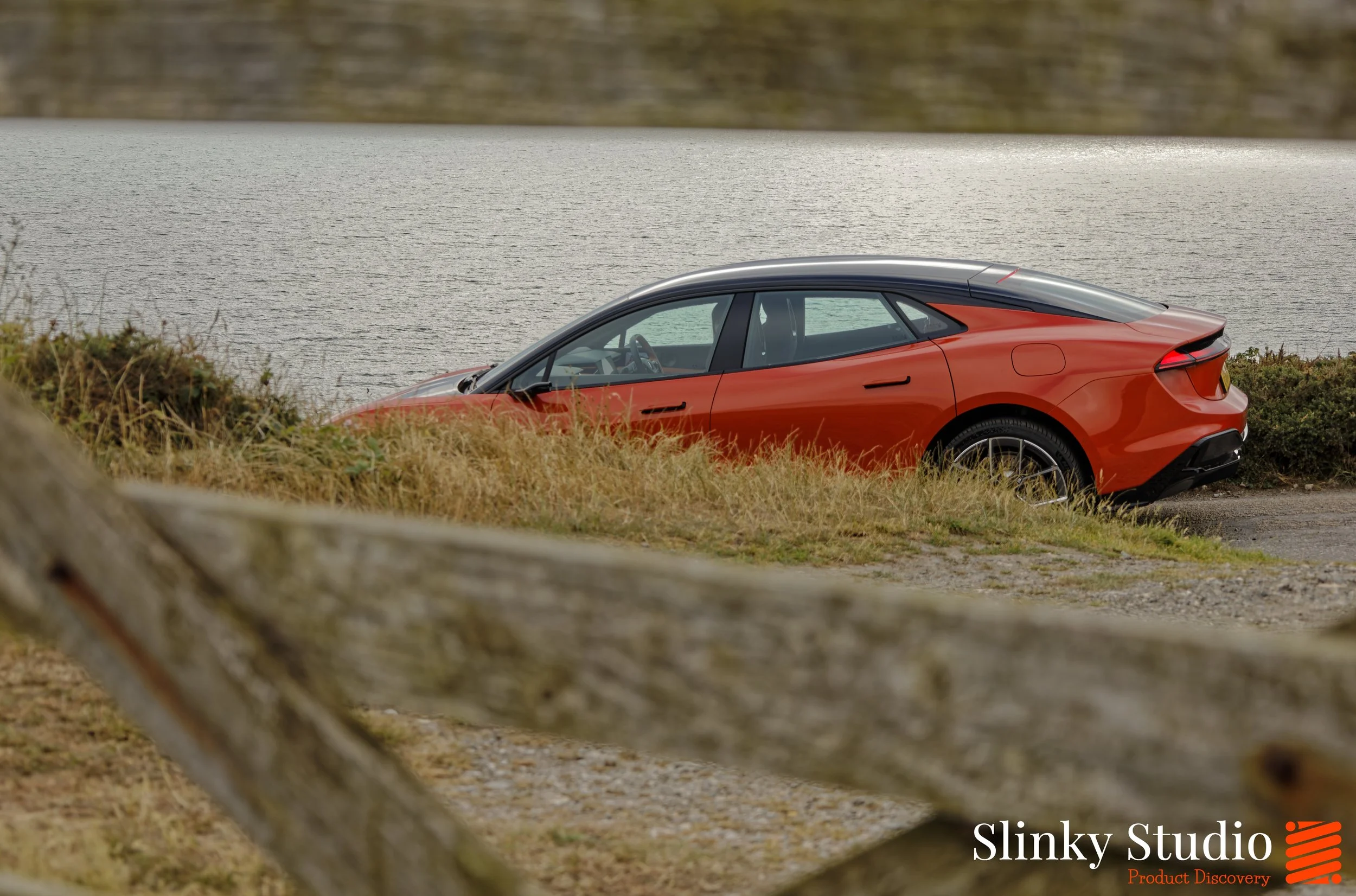 Lotus Emeya Fireglow Orange Driving Next to Sea.jpg
