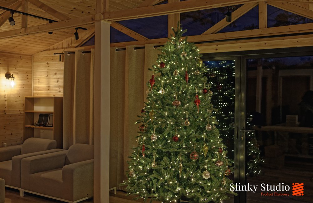 https://images.squarespace-cdn.com/content/v1/54b93453e4b06e38ad5db55b/75fe5439-be3a-4e72-8faa-f61892fa12e5/King+of+Christmas+King+Fraser+Fir+Tree+in+wooden+studio+cabin+in+front+of+bi-folding+doors+twinkly.jpg?format=1000w
